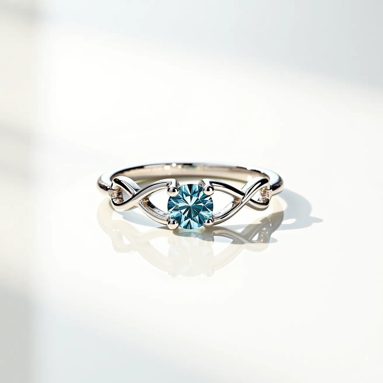 This silver promise ring showcases a delicate and intricate design, featuring a beautifully set round-cut blue gemstone at its center. The stone, held securely by a four-prong setting, is the highlight of this elegant piece. The band displays a graceful intertwining pattern that adds a touch of sophistication and elegance to the overall design. The use of silver contributes to the ring’s sleek appearance, complementing the cool hue of the gemstone and ensuring a timeless and classic look.