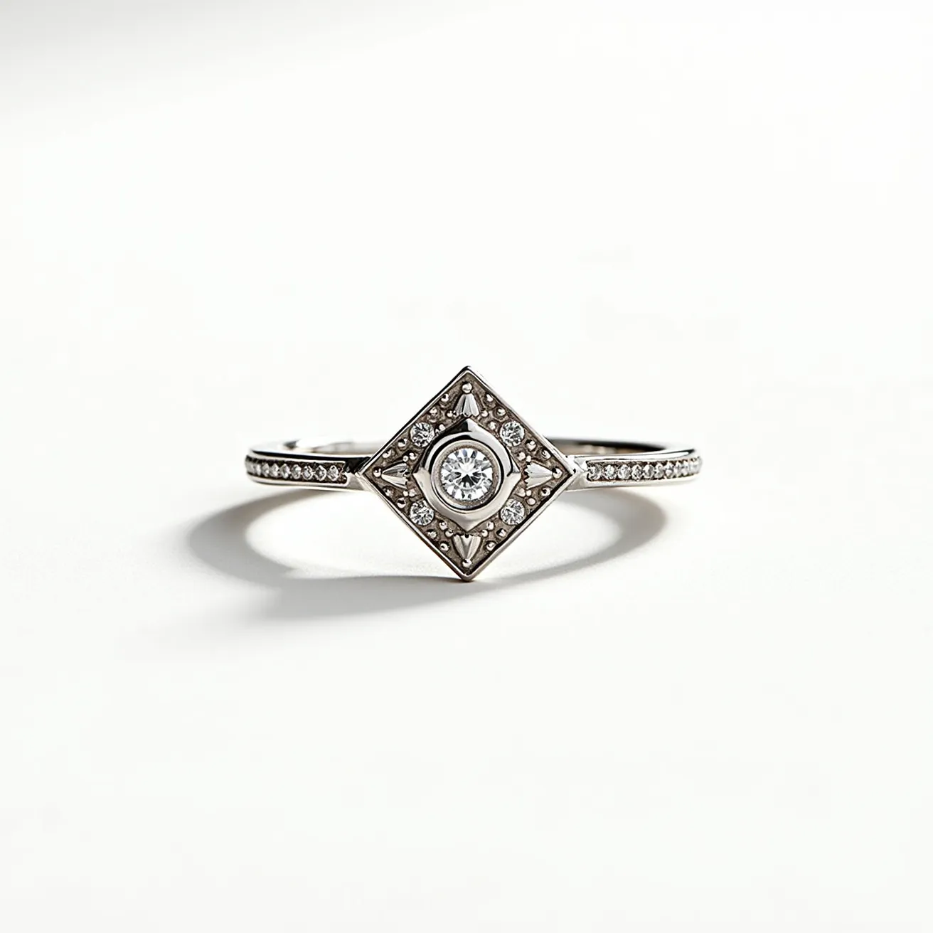 This silver promise ring features a central round-cut gemstone, likely a diamond or a diamond simulant, set within a square-shaped setting that adds a geometric elegance to the design. The primary stone is surrounded by smaller, sparkling stones embedded in a symmetrical pattern, enhancing the ring's brilliance. The band itself is adorned with a series of tiny, evenly spaced stones, contributing to its refined aesthetic, and the setting showcases fine metalwork that complements the overall design. The ring, made of silver, is polished to a smooth finish, highlighting the radiance of the stones and the expert craftsmanship involved in its creation.