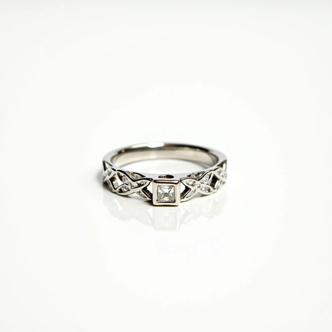 This silver wedding ring features a lattice-like pattern with intricate detailing that enhances its elegance. The centerpiece is a square-cut gemstone, securely set within a bezel setting, which provides a modern yet timeless look. The silver material of the ring enhances the gleam of the stone, creating a sophisticated contrast. The design ensures a comfortable fit, with no clasps or attachments needed.