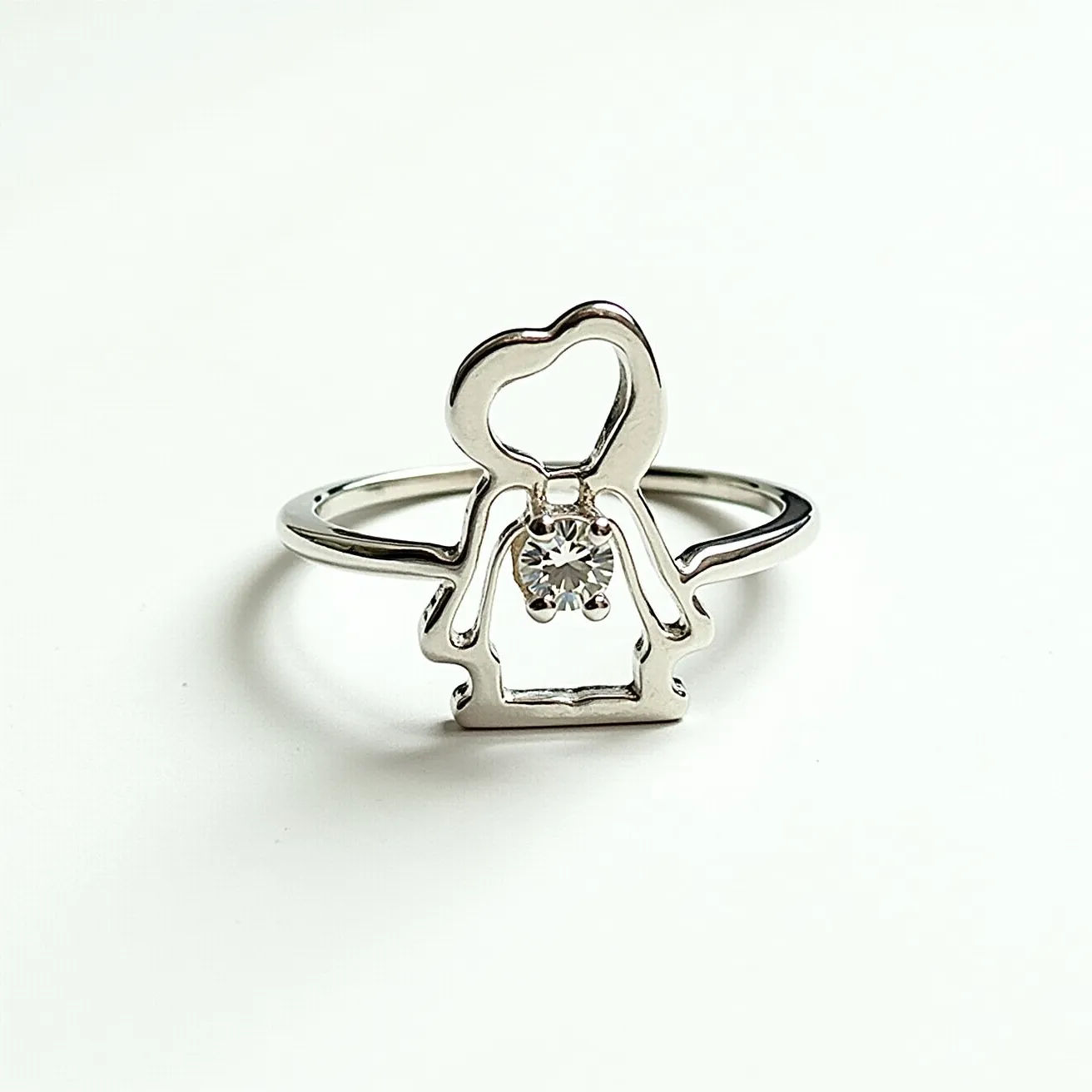 This Snoopy ring is crafted from a shiny metal, likely silver or white gold, giving it a sleek, polished appearance. It features an open design in the shape of the well-known character Snoopy, with a charming, minimalist approach. At the center of Snoopy's figure, there is a round-cut gem, possibly a diamond or cubic zirconia, securely set in a simple prong setting that adds a touch of sparkle to the piece. The band is smooth and slender, enhancing the delicate and elegant design of the ring. This intricate representation captures a playful yet sophisticated aesthetic, perfect for fans of the beloved character.