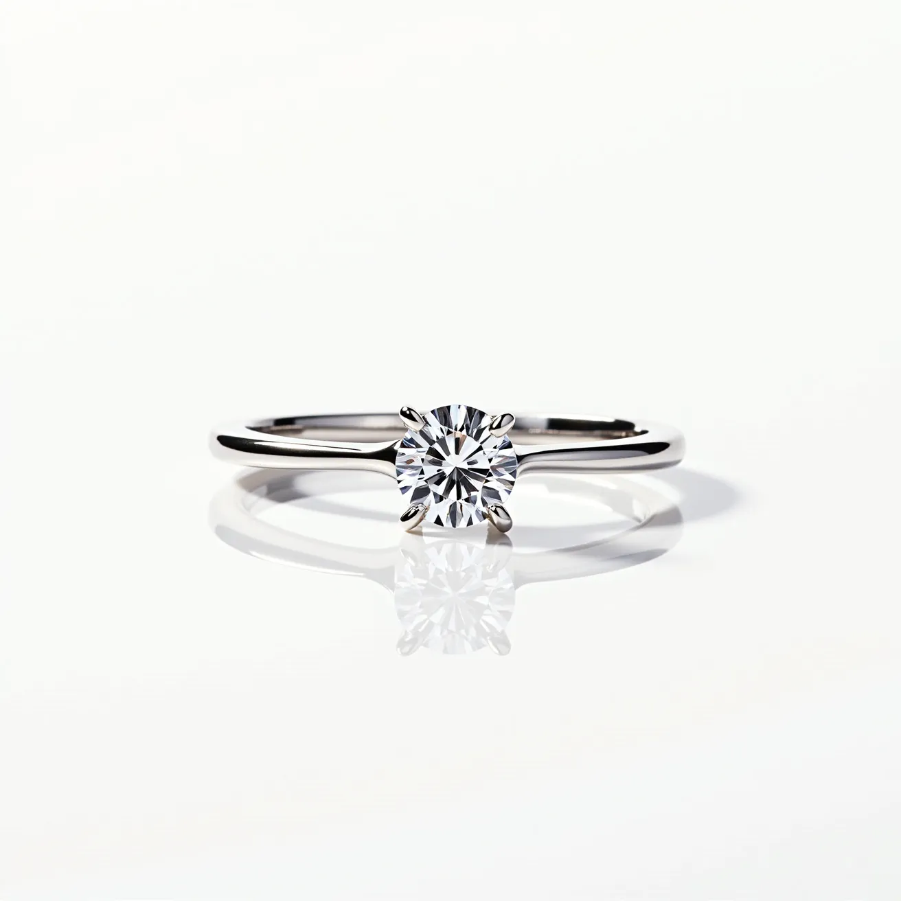 This solitaire ring features a sleek, polished band made of what appears to be white gold or platinum, offering a modern and elegant look. At its center, it showcases a brilliant round-cut diamond that is securely held in place by a classic four-prong setting, allowing maximum exposure to light for enhanced brilliance. The simplicity of the design highlights the solitaire diamond, making it the focal point of this timeless piece. The ring does not include any additional embellishments or complex attachments, emphasizing the purity and elegance of the single gemstone.