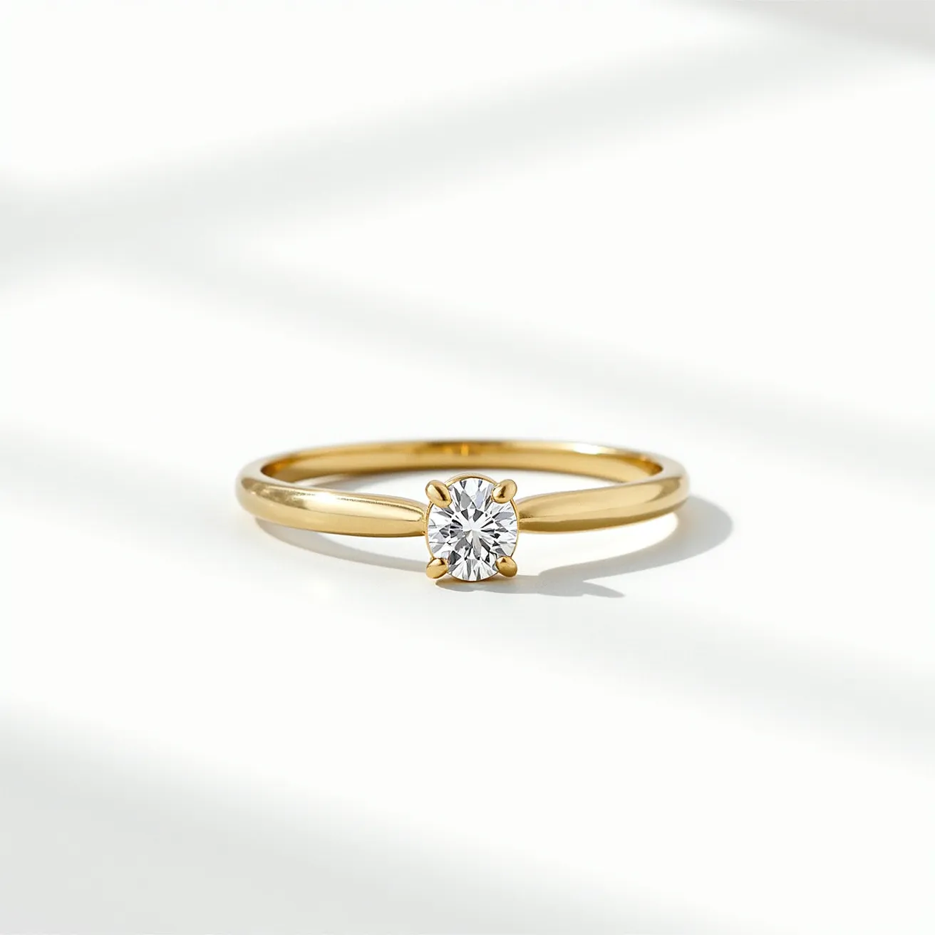 This solitaire ring features a classic design with a round brilliant-cut diamond as its centerpiece. The diamond is held securely in place by a four-prong setting, which allows maximum light to enter the stone, enhancing its brilliance and sparkle. The band of the ring is crafted from polished yellow gold, providing a warm contrast to the clear, bright stone. The sleek and simple design of the band complements the elegance of the diamond, making the ring an enduring symbol of elegance and sophistication.