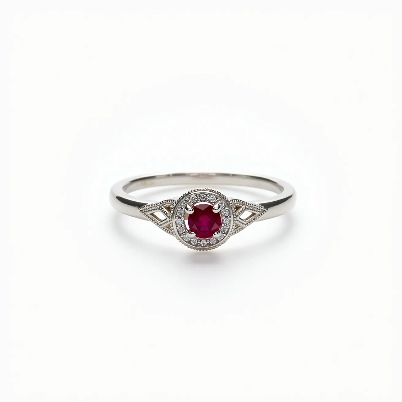 This solitaire ring showcases a striking round-cut red gemstone, likely a ruby, set in a classic prong setting. Surrounding the central stone is a halo of small, round-cut accent diamonds, which add a touch of brilliance and elegance to the piece. The band appears to be crafted from white gold, enhancing the ring's sophisticated and timeless look. The ring features intricate milgrain detailing along the edges, adding a vintage charm. Additionally, the band includes decorative openwork designs flanking the center stone, which enhances the overall aesthetic with a delicate and refined appearance.