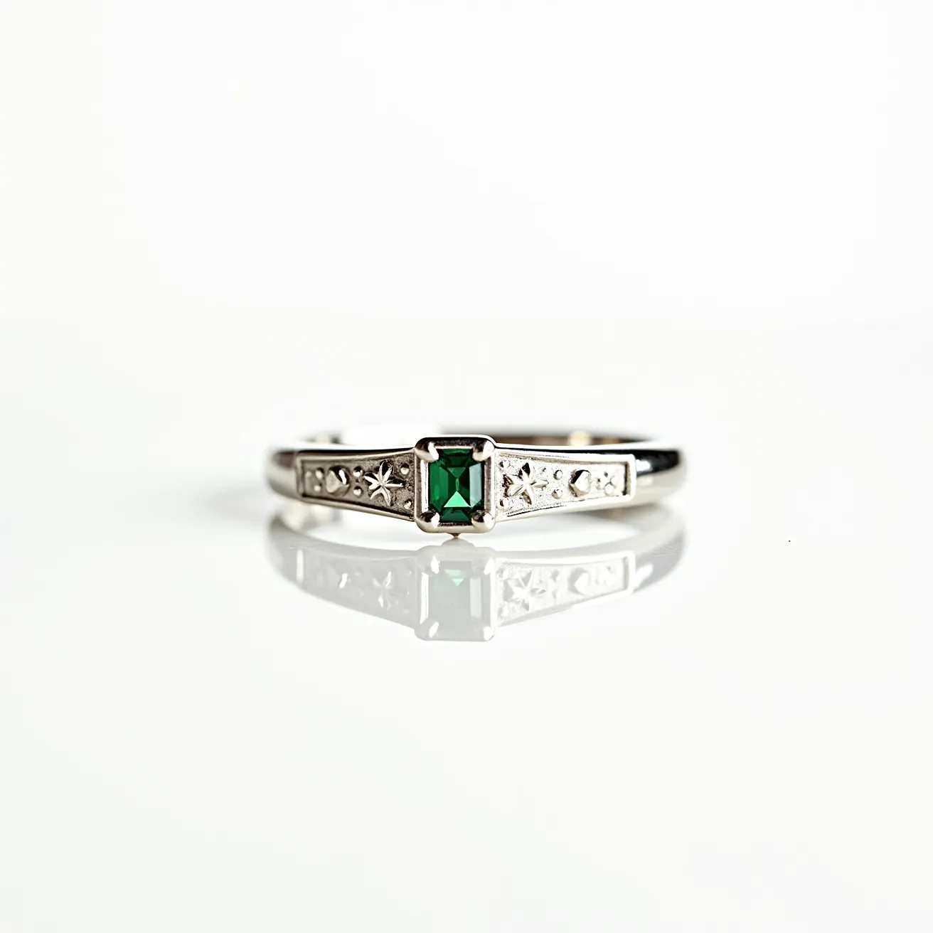 This Solomon's ring is crafted from a lustrous silver metal, featuring an elegant design adorned with star and circle motifs along the band. At its center is a striking emerald-cut green gemstone, securely set in a prong setting that heightens its vibrant color. The band is detailed with intricate patterns, adding a touch of sophistication and artistry to the piece. The combination of the vivid green stone with the cool silver tones creates a harmonious and eye-catching jewelry item.