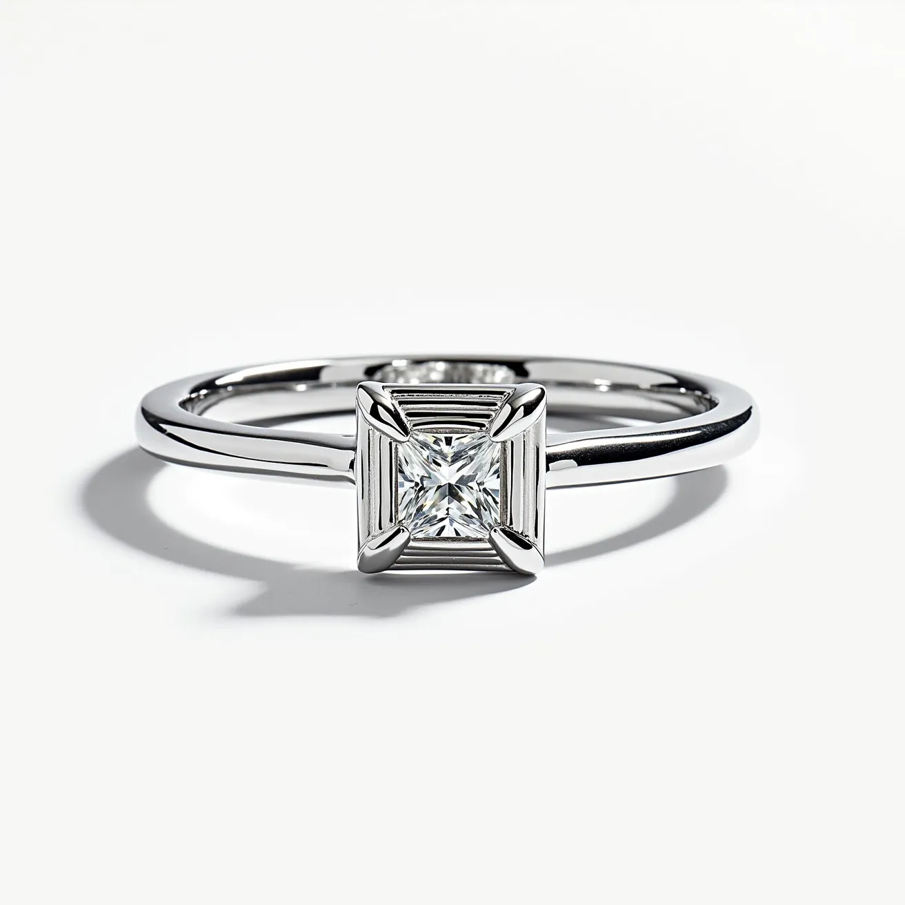 This square ring showcases a sleek and modern design with a polished metal band, likely made of white gold or platinum, emphasizing its sophisticated look. It features a central square-cut gemstone, possibly a diamond, that is neatly set within a four-prong setting, enhancing the stone's brilliance and security. The setting is elevated slightly to allow light to pass through, maximizing the gemstone's sparkle. The clean lines and geometric form of the ring add to its contemporary appeal, making it a striking piece of jewelry.