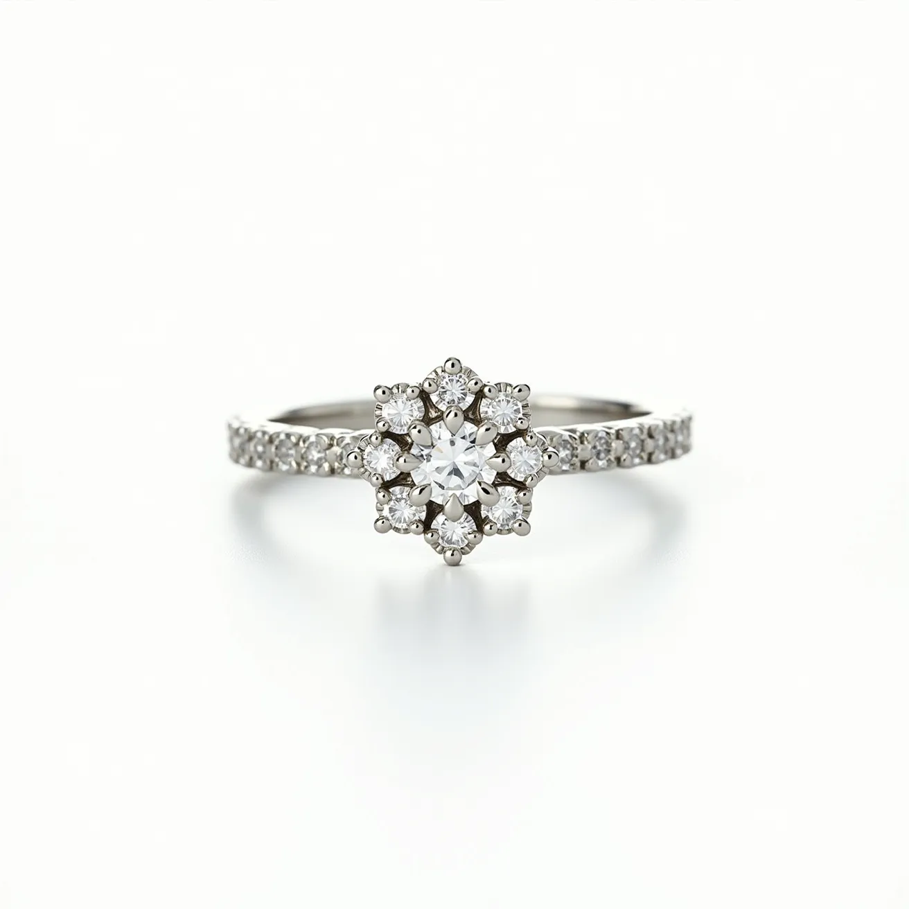 This stackable diamond ring features a central round-cut diamond set in a delicate, star-shaped halo comprised of smaller round diamonds, all placed in a prong setting. The band of the ring is crafted from a lustrous metal, likely white gold or platinum, and is adorned with additional small round diamonds set closely together, enhancing the ring's sparkle and elegance. The design allows for stacking with other rings, making it a versatile addition to any jewelry collection. The ring lacks any visible clasps or attachments, indicating a standard ring form designed for easy wear.