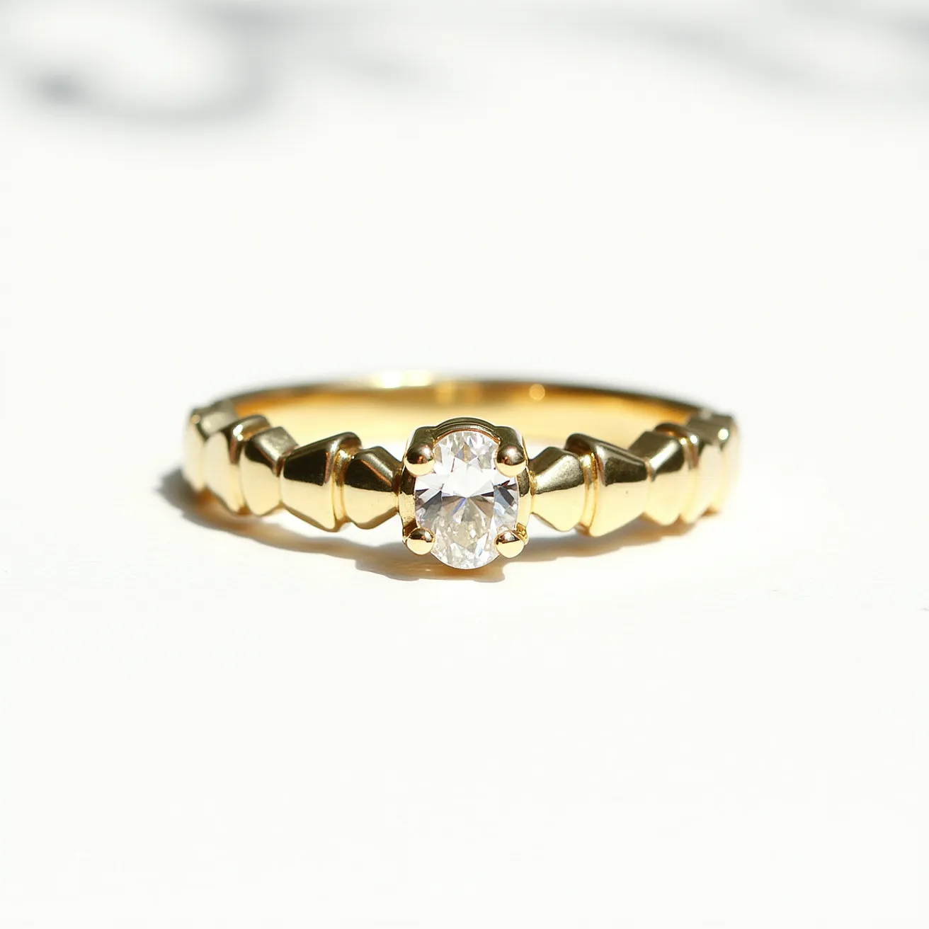 This stackable diamond ring features a brilliant-cut diamond set in a four-prong setting, emphasizing its elegant design and sparkle. The band is crafted from polished gold, enhancing the ring’s luxurious appeal. The band is adorned with angular, geometric elements that add a modern touch to the design while maintaining a refined aesthetic.