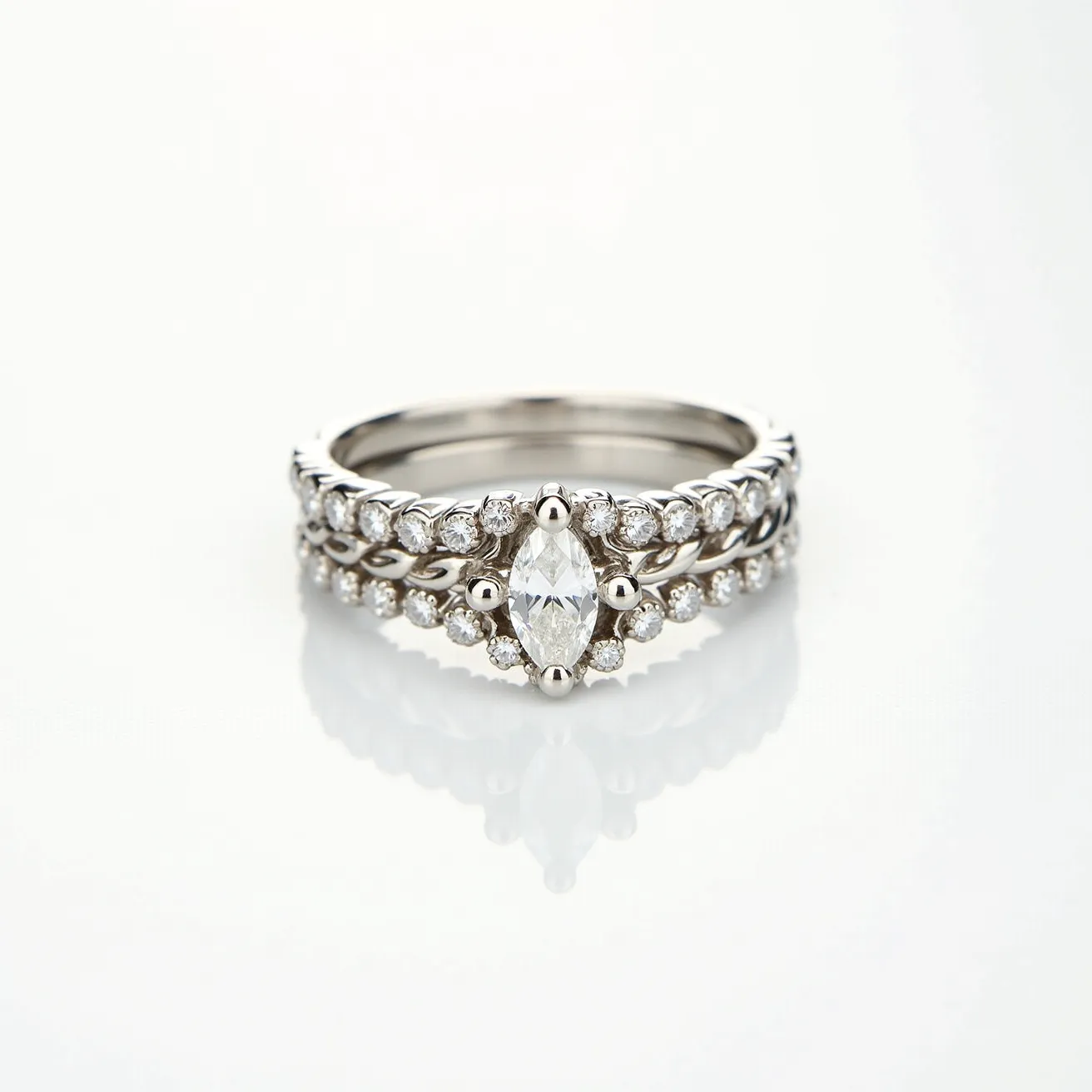 This stackable engagement ring showcases a sophisticated design with a marquise-cut central diamond, elegantly set horizontally. The central stone is surrounded by smaller round brilliant-cut diamonds, which are meticulously arranged in a pavé setting. The ring itself appears to be crafted from a polished white metal, likely white gold or platinum, enhancing the brilliance of the diamonds. The overall structure is composed of multiple bands, each adorned with a consistent line of small diamonds, which contribute to its stacked and layered aesthetic. The intricate detailing and seamless integration of the stones provide a harmonized and luxurious appearance without the presence of visible clasps or attachments.