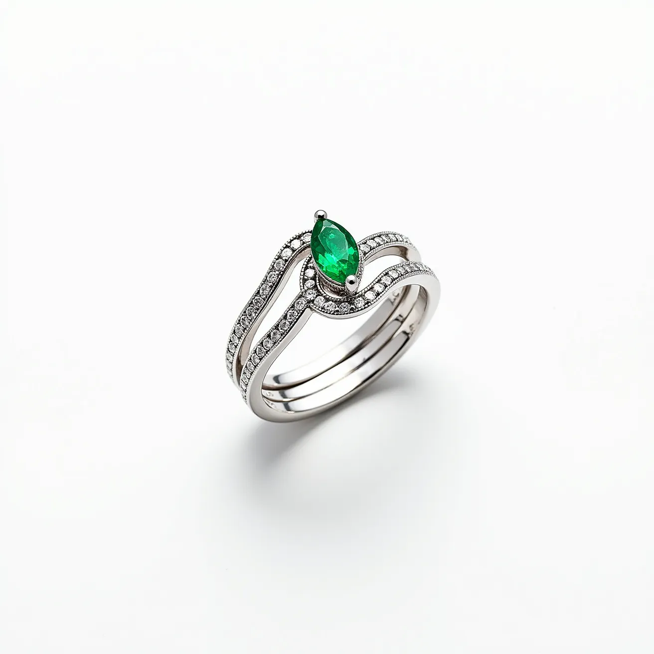 This stackable engagement ring showcases a striking marquise-cut green gemstone at its center, set prominently within a prong setting that ensures security and elegance. Surrounding the central stone, the ring features a series of small, intricately set round diamonds that embellish the band with their sparkling presence, adding a layer of sophistication to the piece. The band itself appears to be crafted from a polished white metal, likely white gold or platinum, which complements the brilliance of the gemstones and provides a sleek, modern aesthetic. The design of the ring allows for seamless stacking, enhancing its versatility and personalization for wearers who wish to combine it with other pieces.
