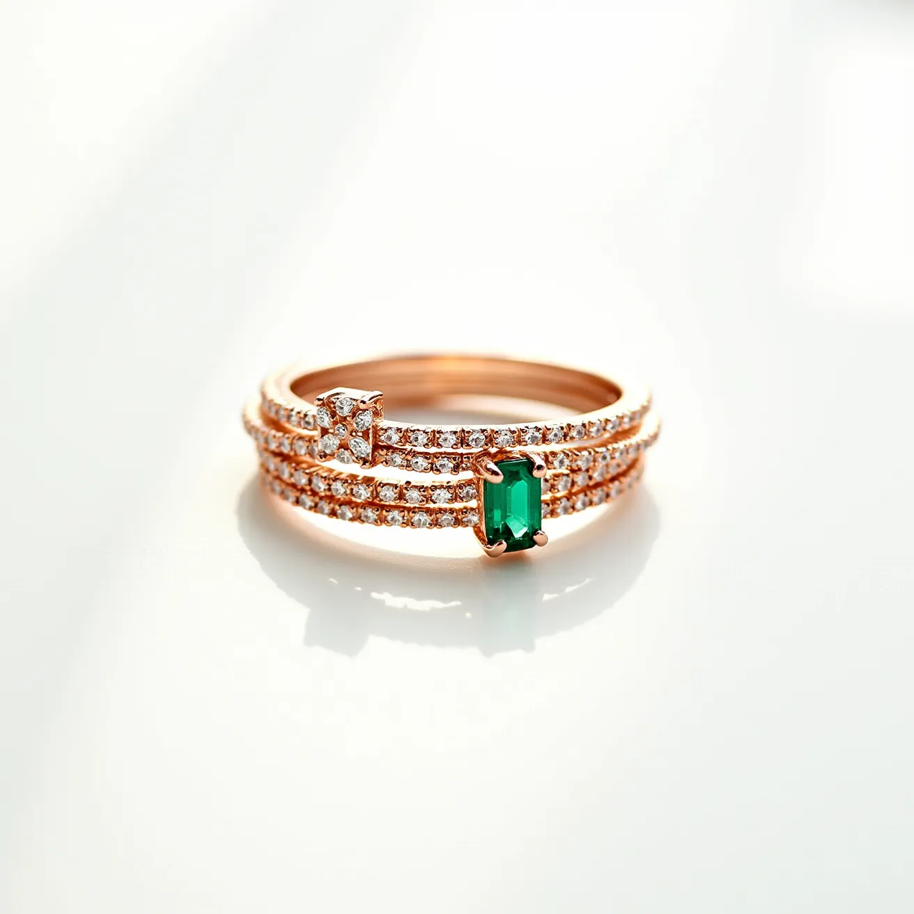 These stackable rings feature a sophisticated design crafted from rose gold. The rings are adorned with clear, round-cut diamonds set closely together in a pave style, creating a sparkling ensemble. Prominently featured on one ring is an emerald-cut green gemstone, secured in a classic four-prong setting, adding a vibrant pop of color. Another ring showcases a raised square setting with additional diamonds, enhancing the overall elegance. The rings have no visible clasps, designed to stack seamlessly together.