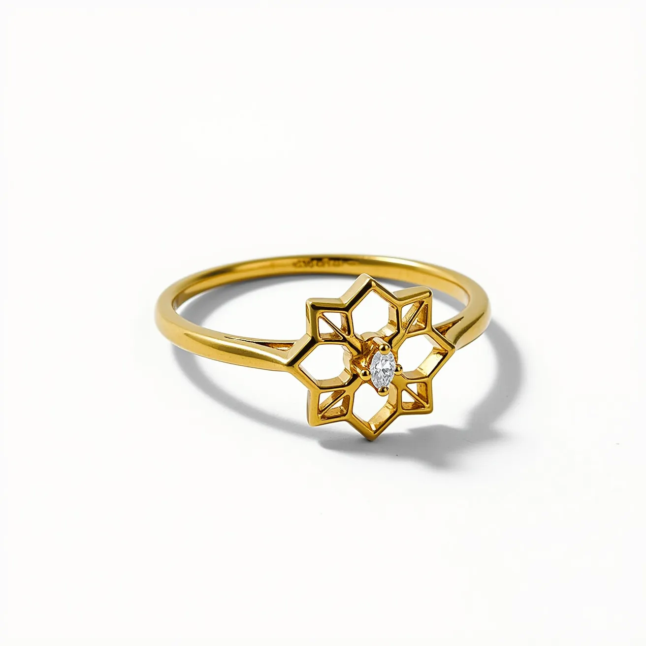 This star ring features a delicate, openwork star design crafted from gold, providing a sleek and polished appearance. At the center of the star motif is a small, marquise-cut white gemstone, likely a diamond, set in a secure prong setting that accentuates its brilliance and clarity. The band itself is a slim, smooth gold band, enhancing the intricate design without overpowering it. The craftsmanship highlights the ring's elegance and modern aesthetic, making it suitable for both everyday wear and special occasions.