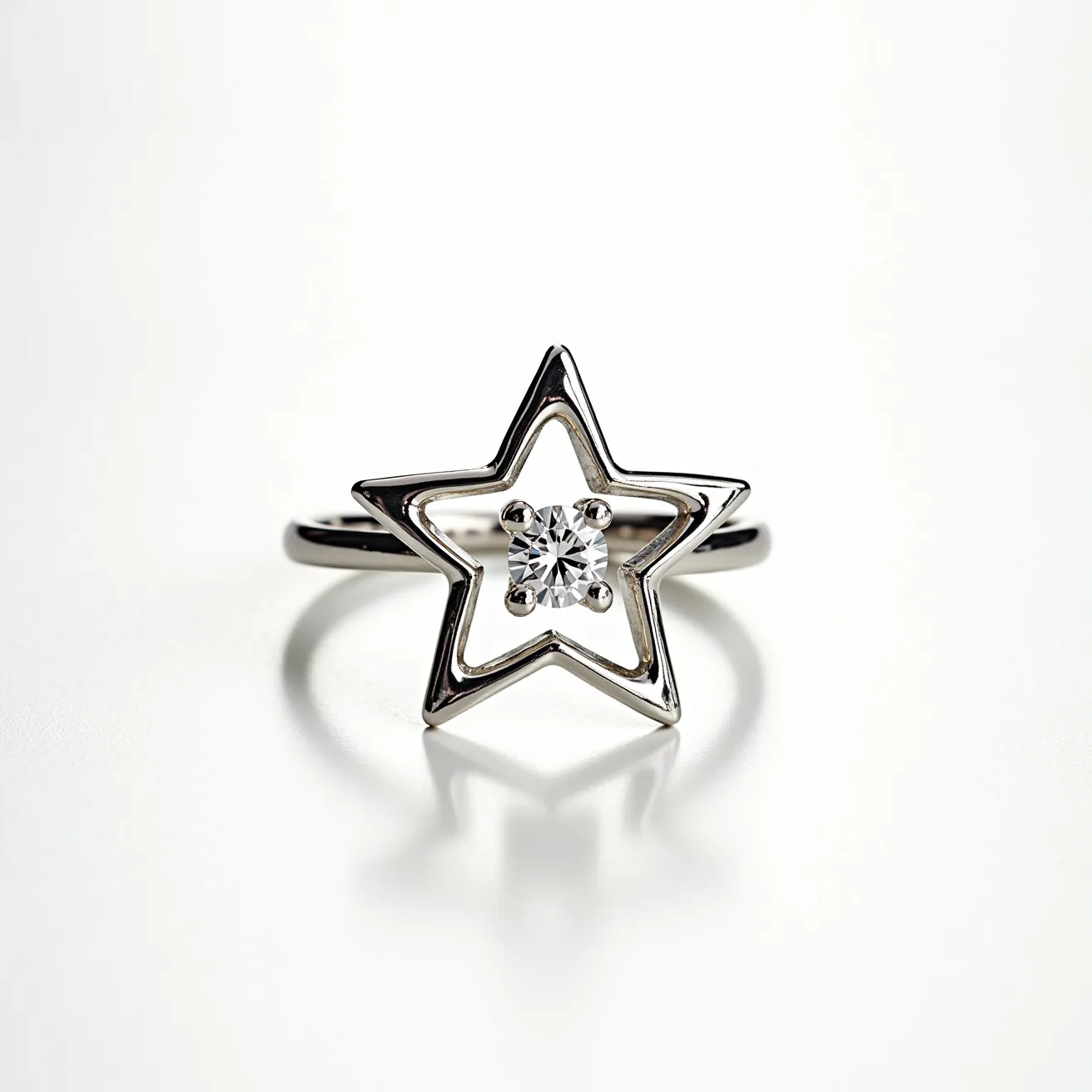 This star ring features a sleek open star design crafted from a polished metal, likely silver or white gold, providing a contemporary and elegant appearance. At the center of the star is a single, round-cut diamond set in a classic four-prong setting, allowing the gemstone to capture and reflect light brilliantly. The ring band is smooth and unembellished, highlighting the standout star motif and diamond centerpiece without additional clasps or attachments. The minimalist style combined with the sparkling gem makes it both modern and timeless.