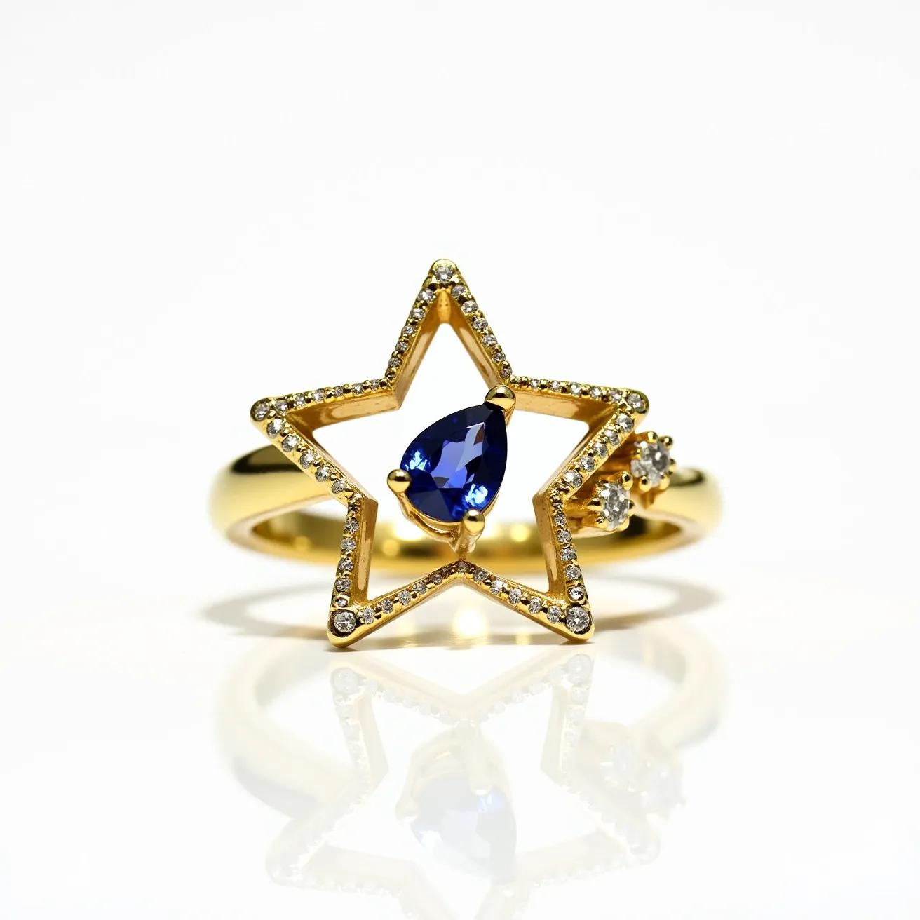 This star ring features a captivating design crafted from a polished gold material, giving it a luxurious and elegant appearance. The central element of the ring is a star-shaped frame adorned with small, sparkling gemstones, likely diamonds, pave-set around its edges. At the heart of the star lies a pear-cut deep blue sapphire secured in a prong setting, adding a vibrant contrast and focal point to the piece. Adjacent to the star, atop the gold band, are additional round gemstones, similarly set, enhancing the ring's dazzling aesthetic. The overall composition combines intricate detailing with the boldness of the central sapphire, offering a harmonious balance of elegance and modern design.