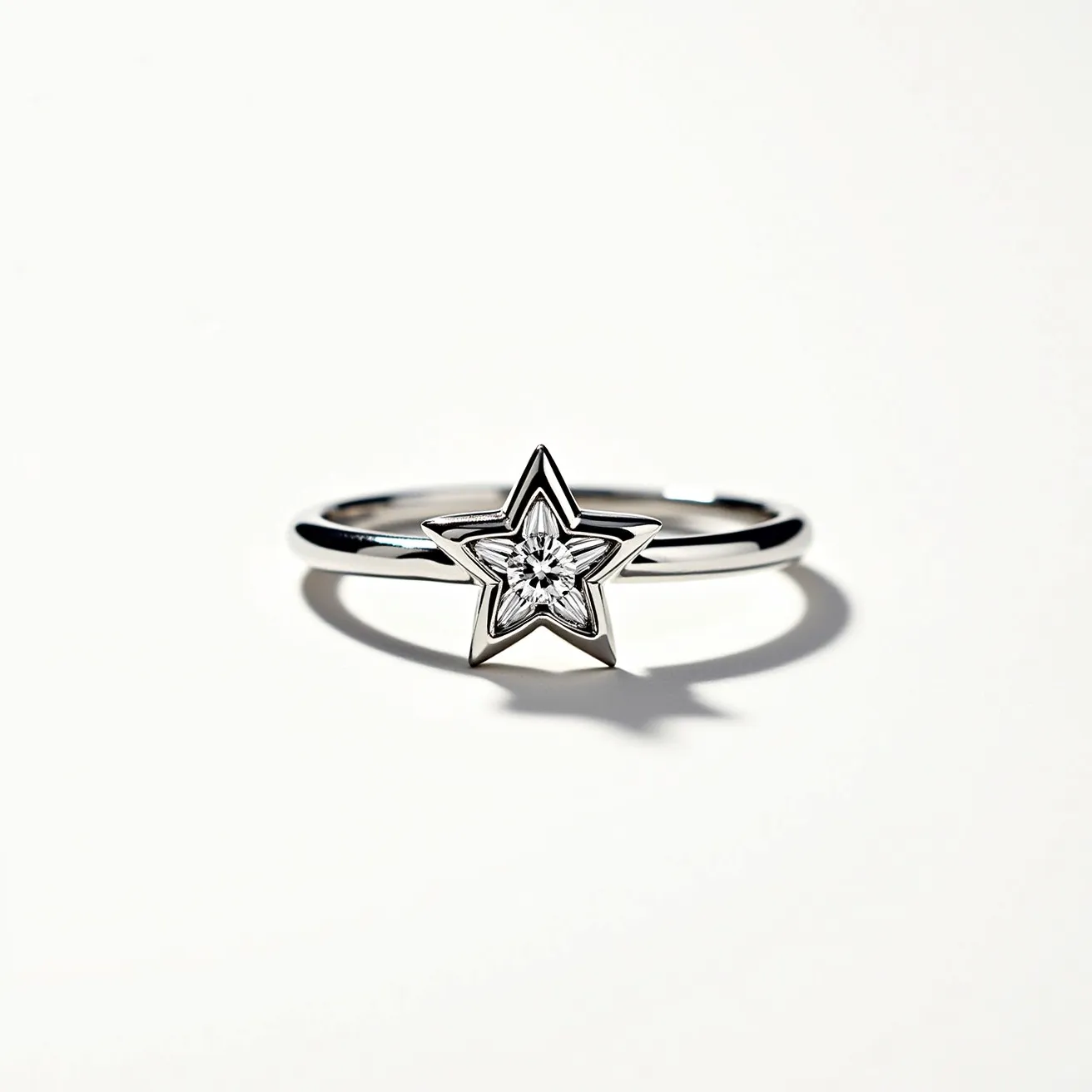 This star ring features a sleek, likely metal band, exhibiting a polished, reflective finish that enhances its elegant appearance. At its center, the ring showcases a star-shaped motif, intricately designed to hold a gemstone. The gem appears to be a round-cut diamond or a similar clear stone, set securely within the star, adding a touch of sparkle. The setting seems to be a bezel or flush type, providing both style and protection for the gem. Overall, the ring has no apparent clasps or attachments, indicating a straightforward slip-on design.