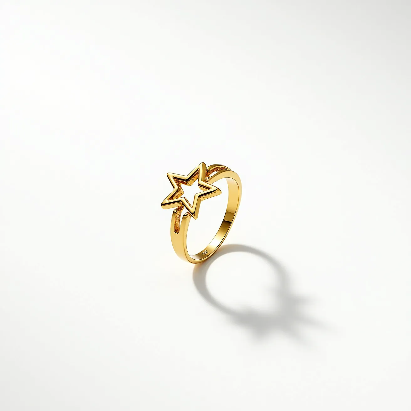 This star ring showcases a minimalist and modern design, primarily composed of smooth, polished metal that appears to be gold. The most striking feature is its star motif, which is crafted with clean lines and an open center, forming an elegant hollow star shape. The star is seamlessly integrated into the band, exhibiting a continuous design without any visible attachments or clasps. There are no gemstones or additional embellishments, emphasizing the simplicity and elegance of the piece through its sleek metallic luster.