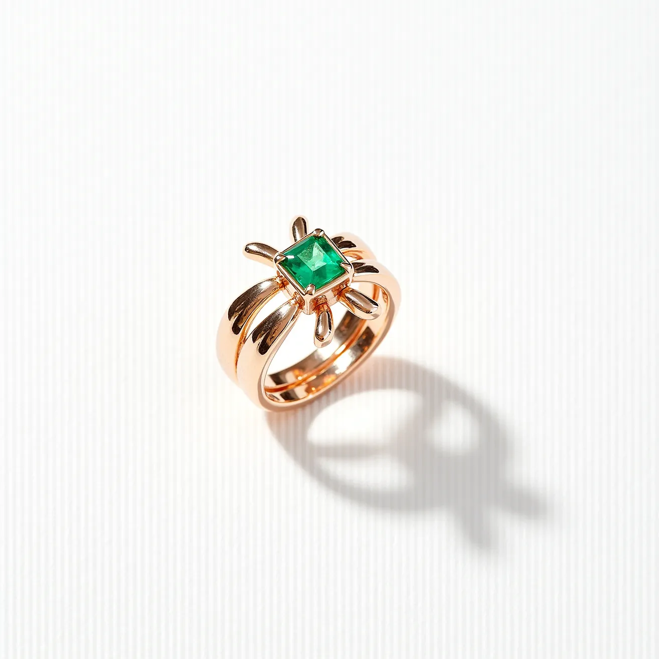 This statement ring features a vibrant green rectangular-cut gemstone set prominently at its center. The gemstone is secured in a prong setting, enhancing its visibility and drawing focus to its rich color. The band of the ring is crafted from a warm-toned metal, likely gold or gold-plated, adding a classic elegance to the piece. The overall design is bold and eye-catching, making it an ideal choice for someone looking to make a fashion statement with their jewelry.