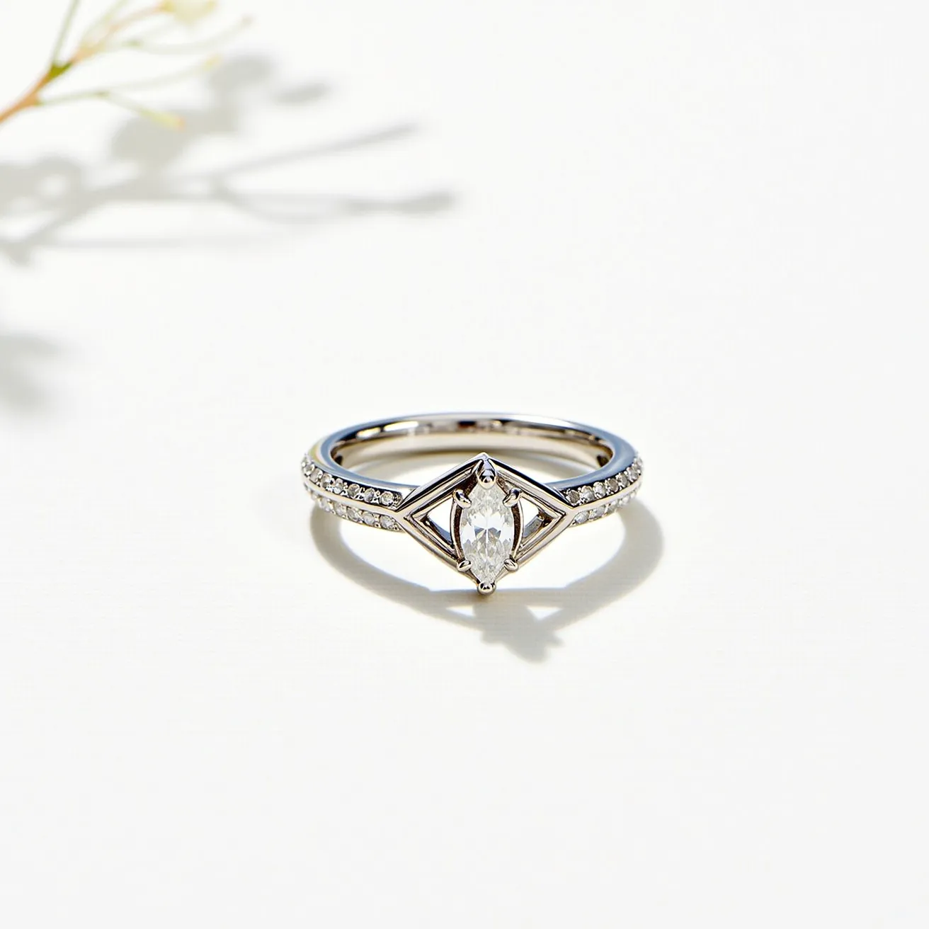 This statement ring features a sleek metal band, likely white gold or platinum, providing a modern and elegant foundation. The centerpiece of the design is a marquise-cut gem, securely held in place with a geometric prong setting that emphasizes its unique shape. Flanking the central stone are small round accent stones set into the band, enhancing the ring's sparkle and offering a complementary contrast to the central gem. The combination of materials and intricate detailing results in a striking and sophisticated accessory.