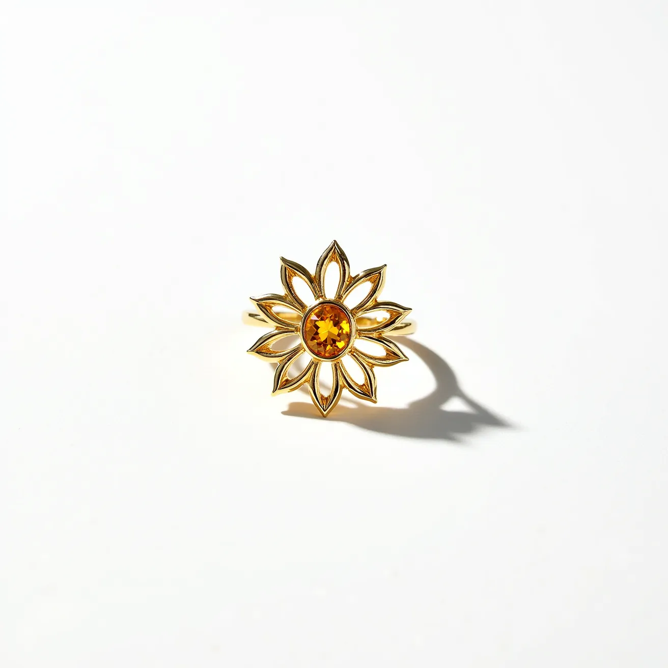 This sunflower ring features a radiant sunflower design crafted from gold-tone metal. The centerpiece of the ring is an oval-cut amber-colored gem that imitates the vibrant core of a sunflower. The gem is securely set in a bezel setting, enhancing its brilliance while ensuring durability. The ring band appears to complement the floral motif seamlessly, highlighting the artistry of the piece. The petals are open and intricately shaped, emphasizing both elegance and nature-inspired beauty.