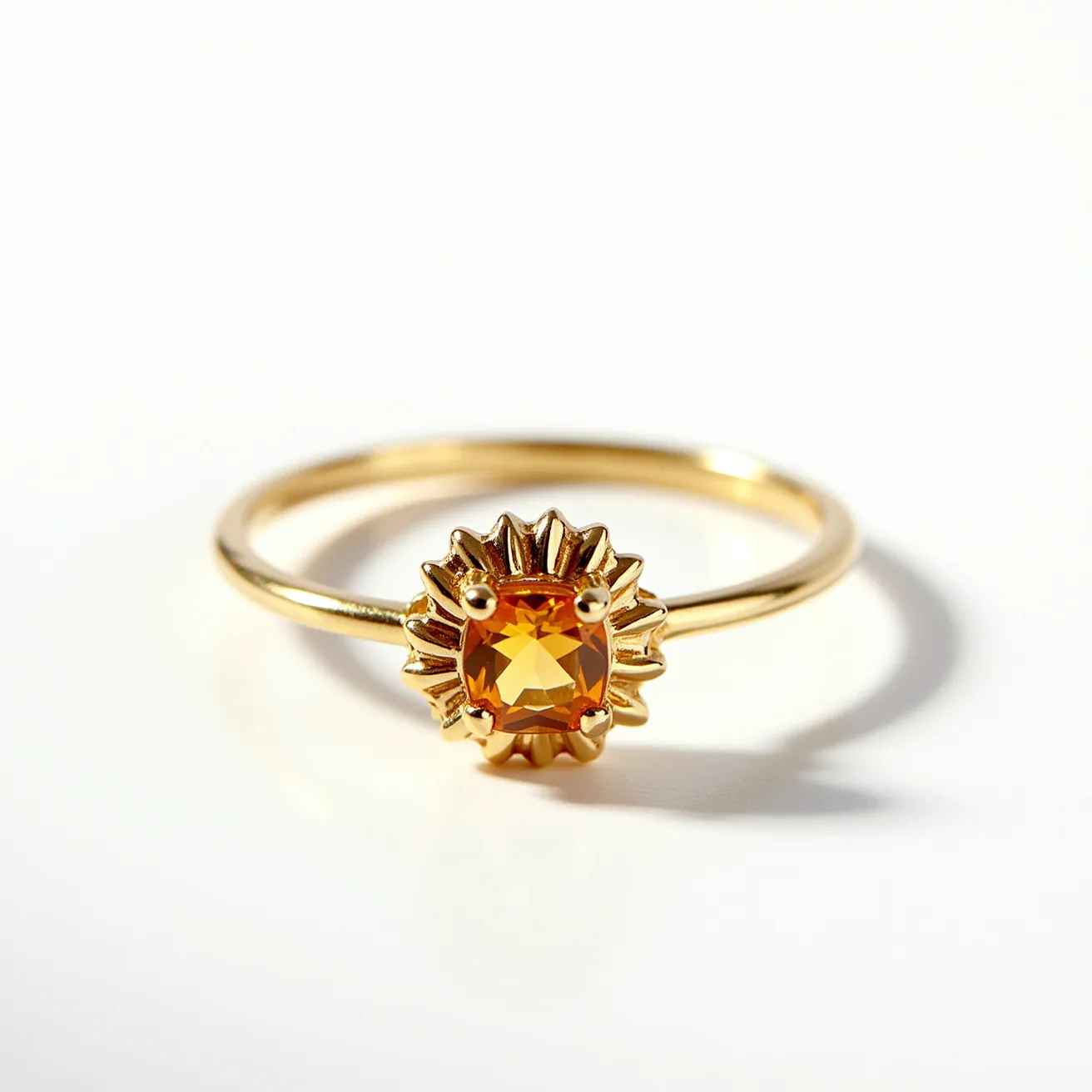 This sunflower ring features a delicate gold band adorned with a central gemstone. The gem is a vibrant yellow-orange, cut in a round or cushion shape, and is securely set with four prongs which enhance its brilliance. The golden setting is designed to mimic sunflower petals, radiating from the gemstone in an intricate, symmetrical pattern. The craftsmanship reflects careful attention to detail, emphasizing both the beauty of the gem and the symbolic sunflower design.