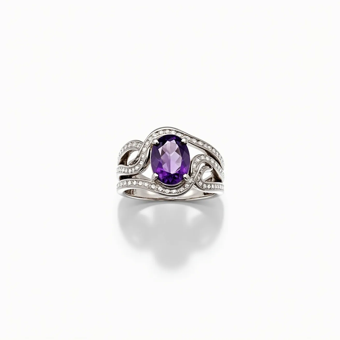 This tangled ring features an elegant design crafted from a polished white metal, likely white gold, which gracefully intertwines to form a sophisticated band. At its center, there is a striking oval-shaped amethyst gemstone, showcasing a deep, regal purple hue and precision cuts that enhance its brilliance. The amethyst is securely held by a classic four-prong setting, ensuring stability and prominence. Surrounding the amethyst are delicate, intertwining metal strands embellished with numerous small, sparkling diamonds, adding a complementary shimmer to the piece. These diamonds are set in a pave style, contributing to the ring's intricate and luxurious appearance.