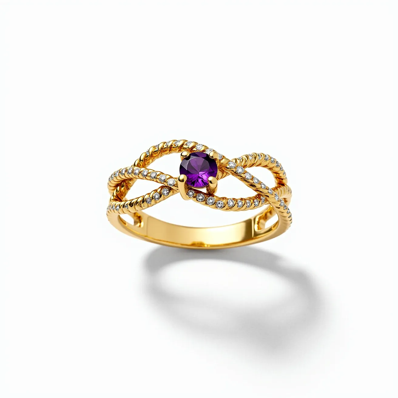 This tangled ring features an intricate design crafted from a luminous gold metal, elegantly twisted into an interwoven pattern. At its center, a vibrant round-cut purple gemstone is held securely in a four-prong setting, capturing attention with its rich hue. The band itself is adorned with a series of small, clear stones, likely diamonds, set in a dazzling pavé style that accentuates the opulence of the piece. The gold metal offers a classic, polished finish, enhancing the overall luxury and sophistication of the ring's design.