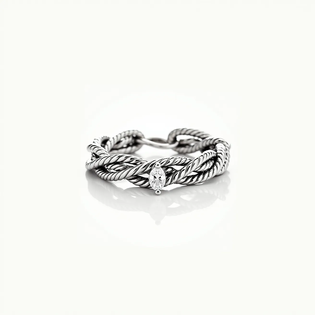 This tangled ring features intricately twisted silver strands creating a rope-like effect, showcasing the artisanal craftsmanship in its design. At the center, a marquise-cut diamond is elegantly set, providing a focal point with its unique elongated shape and brilliant sparkle. The diamond is snugly held in place with a bezel setting, which complements the overall aesthetic of the piece, enhancing both its security and style. The ring's construction suggests durability and an understated elegance, with no visible clasp or attachment, allowing the continuous design to flow seamlessly around the finger.