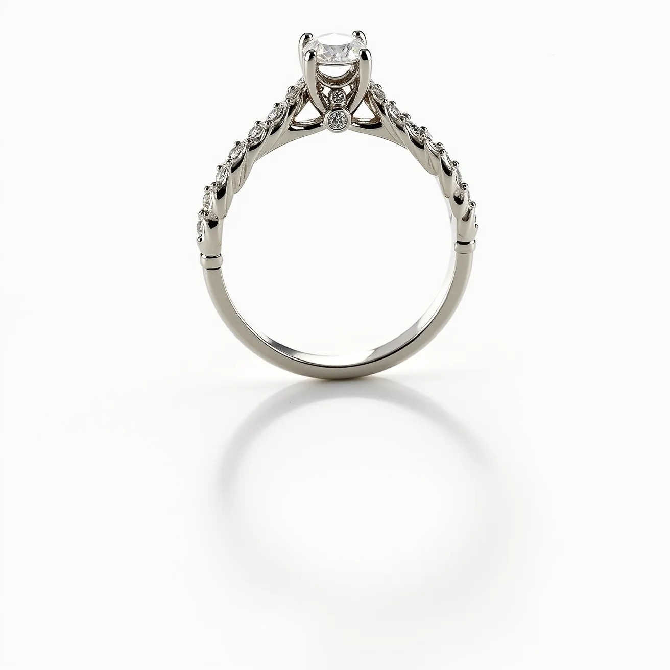 This vine engagement ring features a graceful design crafted from a sleek metal, likely white gold or platinum, providing a polished and elegant appearance. At the center, a round-cut diamond is securely set in a classic six-prong setting, offering maximum brilliance and a secure hold. Along the shank, additional smaller round diamonds are embedded, creating a vine-like pattern that elegantly weaves along the band, enhancing the ring's natural aesthetic. The intricate design showcases artistic craftsmanship, with an emphasis on delicate details that harmonize beautifully with the central diamond's sparkle.