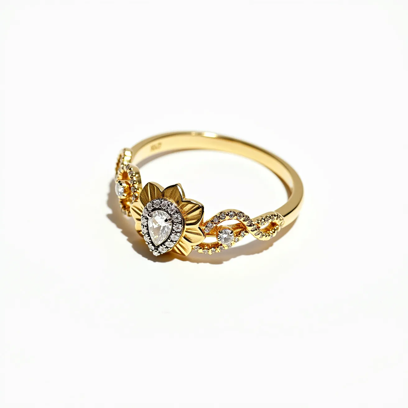 This vine ring features an intricate design crafted from gold-toned metal. At its center, there is a prominent pear-shaped gemstone, possibly a diamond or a crystal, set within a floral motif that resembles petals surrounding the main stone. The main stone is accented by a halo of smaller round-cut gems, adding sparkle and elegance to the piece. Along the band, there are additional small round-cut gems set in a twisting vine-like pattern, enhancing the ring's nature-inspired aesthetic. The ring's band is smooth and polished, adding a contemporary touch to this elegant piece.