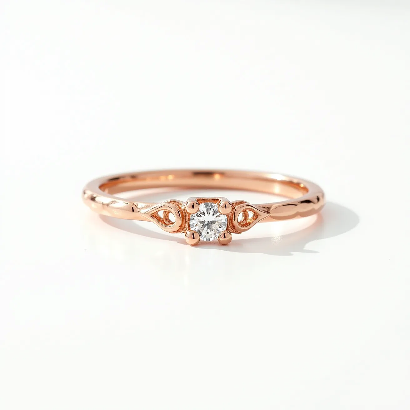 This wedding band is crafted from a polished rose gold material, featuring a delicate and elegant design. At its center, the band showcases a round cut diamond, set in a classic four-prong setting, enhancing its brilliance and ensuring stability. The band is adorned with intricate decorative elements on either side of the diamond, adding a touch of vintage charm and sophistication to the overall aesthetic. There is no visible clasp or attachment, as it is a solid band intended for ease of wear and enduring style.