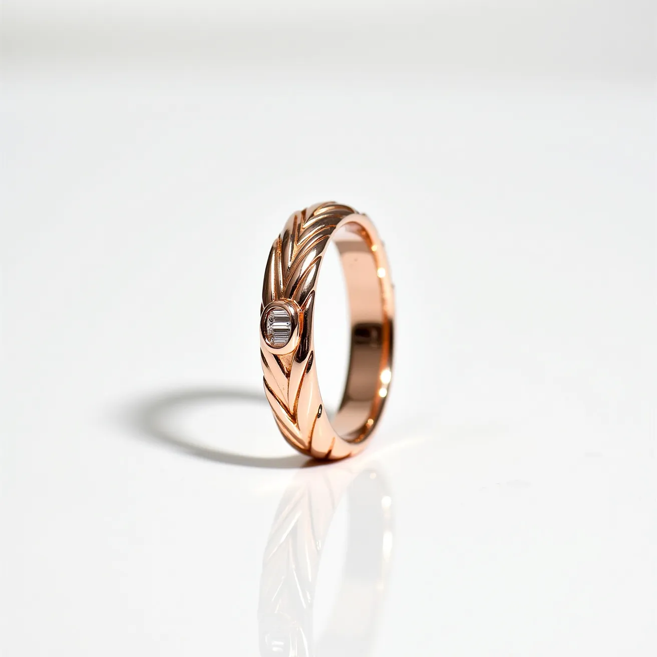 This wedding band is crafted from rose gold and features a unique braided design. It is adorned with a single, oval-cut diamond set in a bezel setting, adding a touch of elegance and sparkle. The band is smoothly polished, enhancing its sophisticated and timeless appearance, making it a beautiful symbol of commitment.