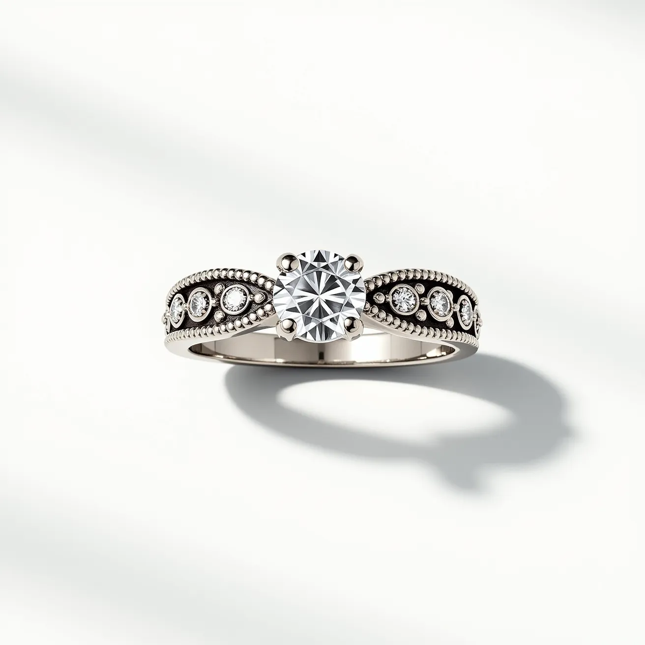 This wedding band features a stunning round brilliant cut diamond as the centerpiece, set in a classic prong setting that elevates the stone for maximum light exposure and brilliance. The band is crafted from a polished white metal, likely platinum or white gold, which complements the clarity and sparkle of the diamonds. The band is adorned with small round diamonds embedded in an ornate design along the sides, each secured by a bezel setting that adds a decorative and protective element to the ring. The intricate beading along the edges of the band enhances its vintage-inspired aesthetic, creating a sophisticated and timeless look.