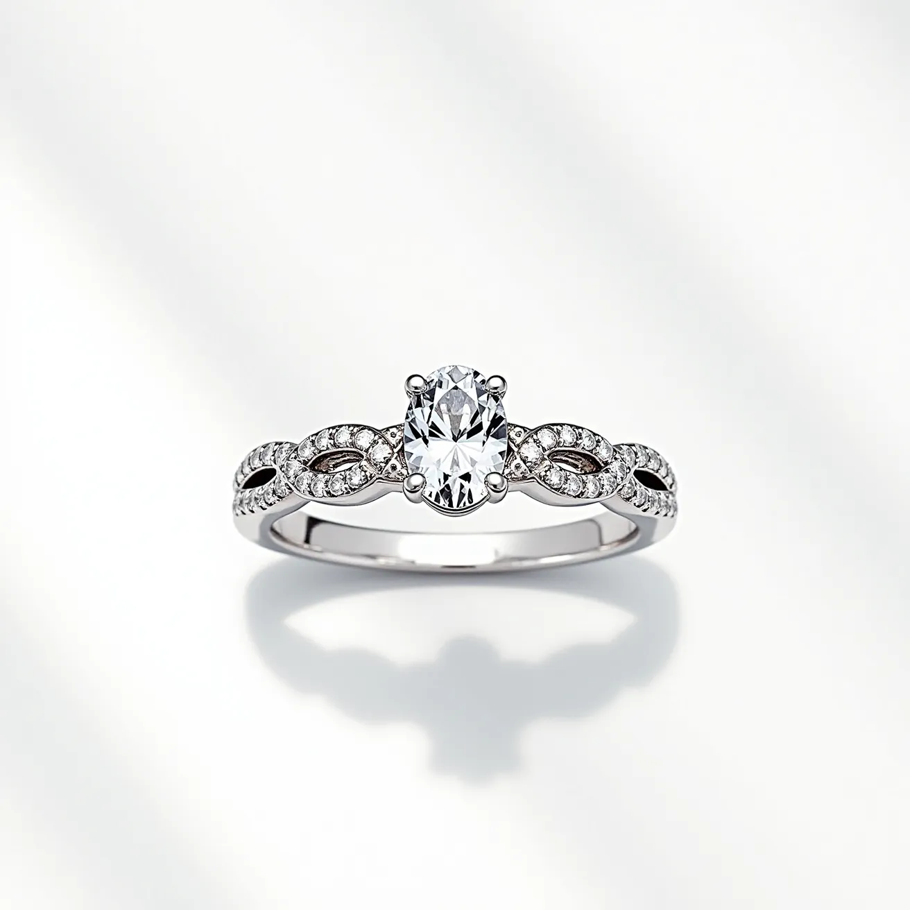 This wedding ring features a central oval-cut diamond set in a four-prong setting, which is a classic choice for showcasing the gem's brilliance. The band is crafted from a lustrous white metal, likely platinum or white gold, providing a refined and elegant appearance. Along the band, smaller round-cut diamonds are intricately set in a marquise-shaped pattern, adding a touch of vintage charm to the design. Each marquise motif is bordered with milgrain detailing, enhancing the overall sophistication and intricate craftsmanship of the piece.