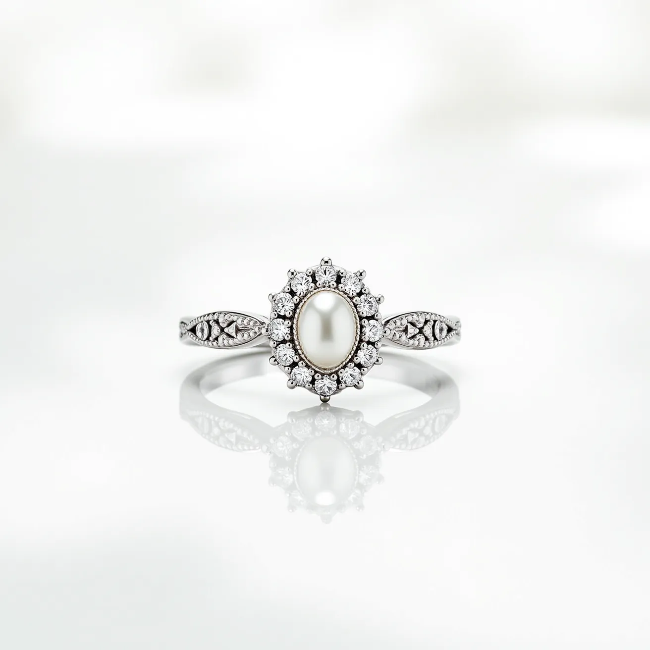 This wedding ring features a polished metal band, likely made from white gold or platinum, adorned with intricate details along the sides. The centerpiece is an oval-shaped pearl, set in a bezel setting, adding an element of classic elegance. Surrounding the pearl are numerous small round-cut diamonds in a halo setting, enhancing the ring's overall brilliance. The combination of the pearl's smooth luster and the diamonds' sparkle creates a timeless and sophisticated appearance.