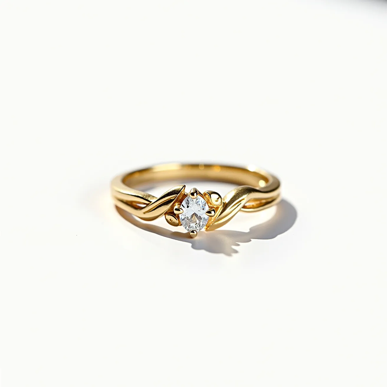 This wedding ring features a delicate gold band with an elegant twist design leading to a central gemstone. The stone appears to be a round brilliant cut diamond, set in a classic prong setting that showcases its brilliance. The gold band is smooth with a lustrous finish, complementing the sparkle of the diamond. This elegant design is timeless, combining simplicity with a touch of sophistication.