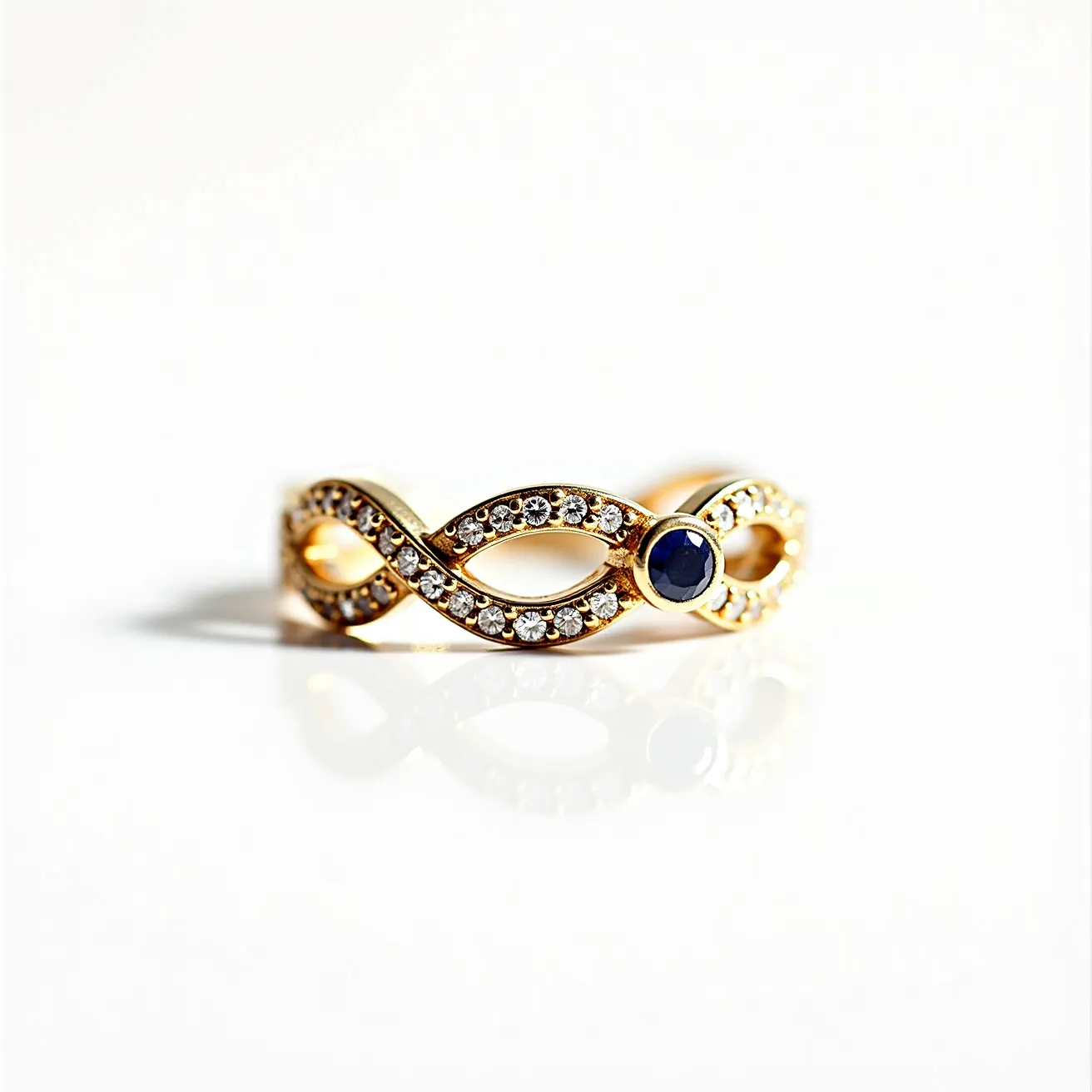 This wedding ring features an elegant gold band designed in an infinity loop pattern. It is adorned with small, round-cut diamonds set along the loops, which add brilliant sparkle and elegance. At one point of the band, a prominent round blue sapphire serves as a focal point, securely held in a bezel setting. The overall design is intricate yet harmonious, combining classic and modern elements with a luxurious touch.