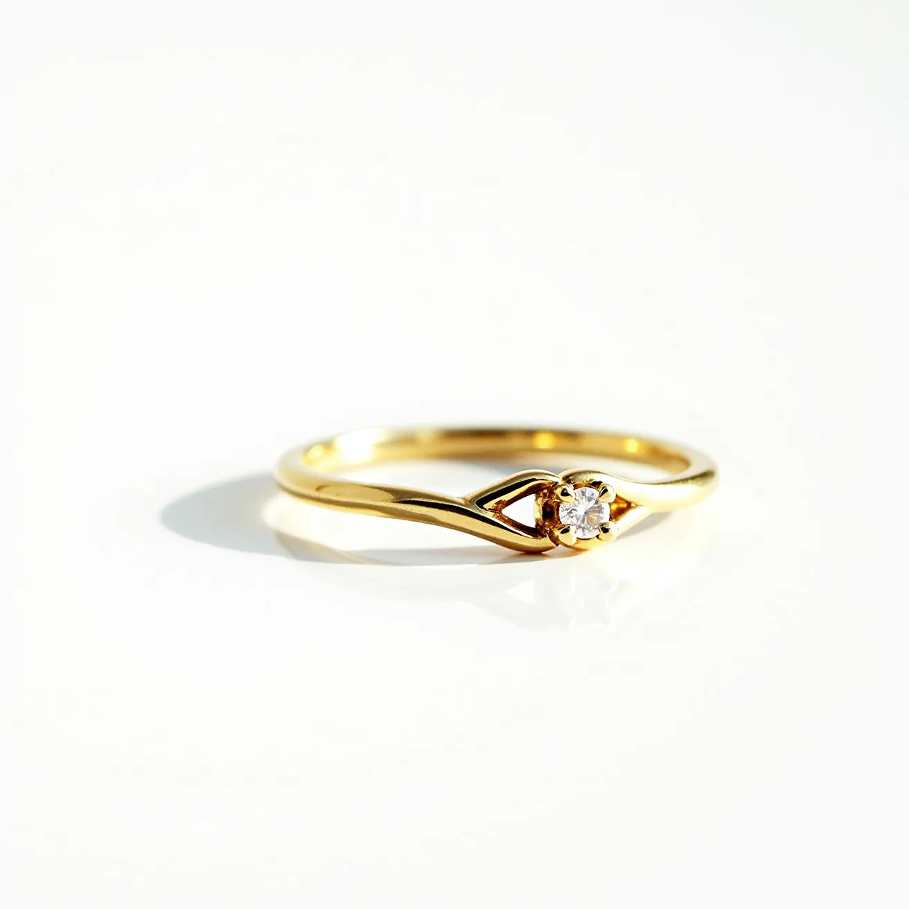 This wedding ring features a slender gold band with an elegant, twisted design that leads to a single, central gemstone. The gemstone appears to be a small round-cut diamond, securely held in place by a four-prong setting. The simple yet sophisticated design of the band highlights the brilliance of the diamond, emphasizing its quality and clarity. The setting allows for the maximum visibility of the stone, adding a touch of sparkle and elegance. The ring showcases a classic and timeless charm, making it a perfect symbol of enduring commitment.