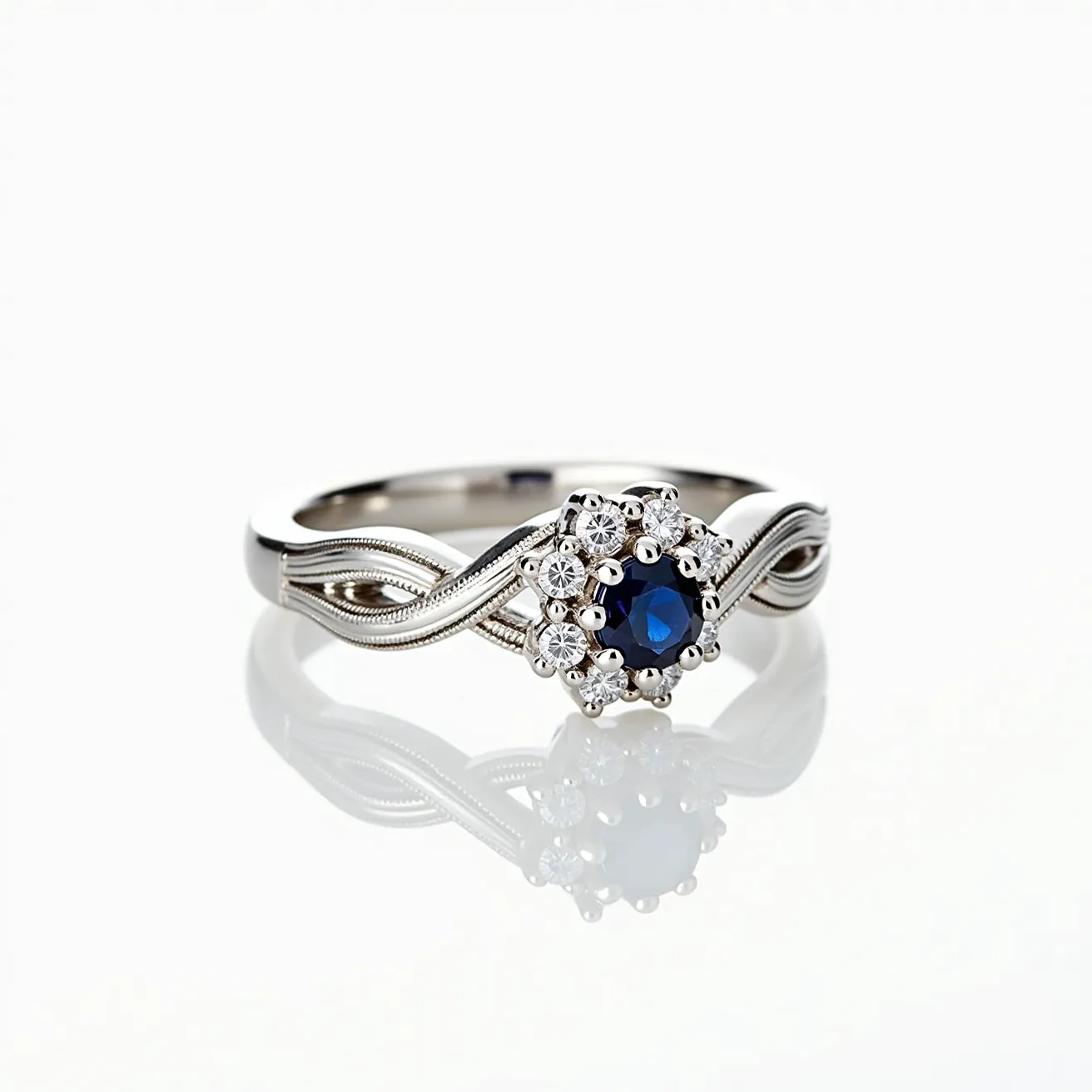 This wedding ring features an intricately designed band crafted from a polished white metal, likely white gold or platinum. It showcases a central blue sapphire gemstone, round in shape, elegantly set in a prong setting. Surrounding the sapphire is a halo of small, round-cut diamonds, also secured with prongs, enhancing the central stone's brilliance. The ornamental band exhibits a twisted design, adding a touch of sophistication and charm to the ring’s overall appearance.