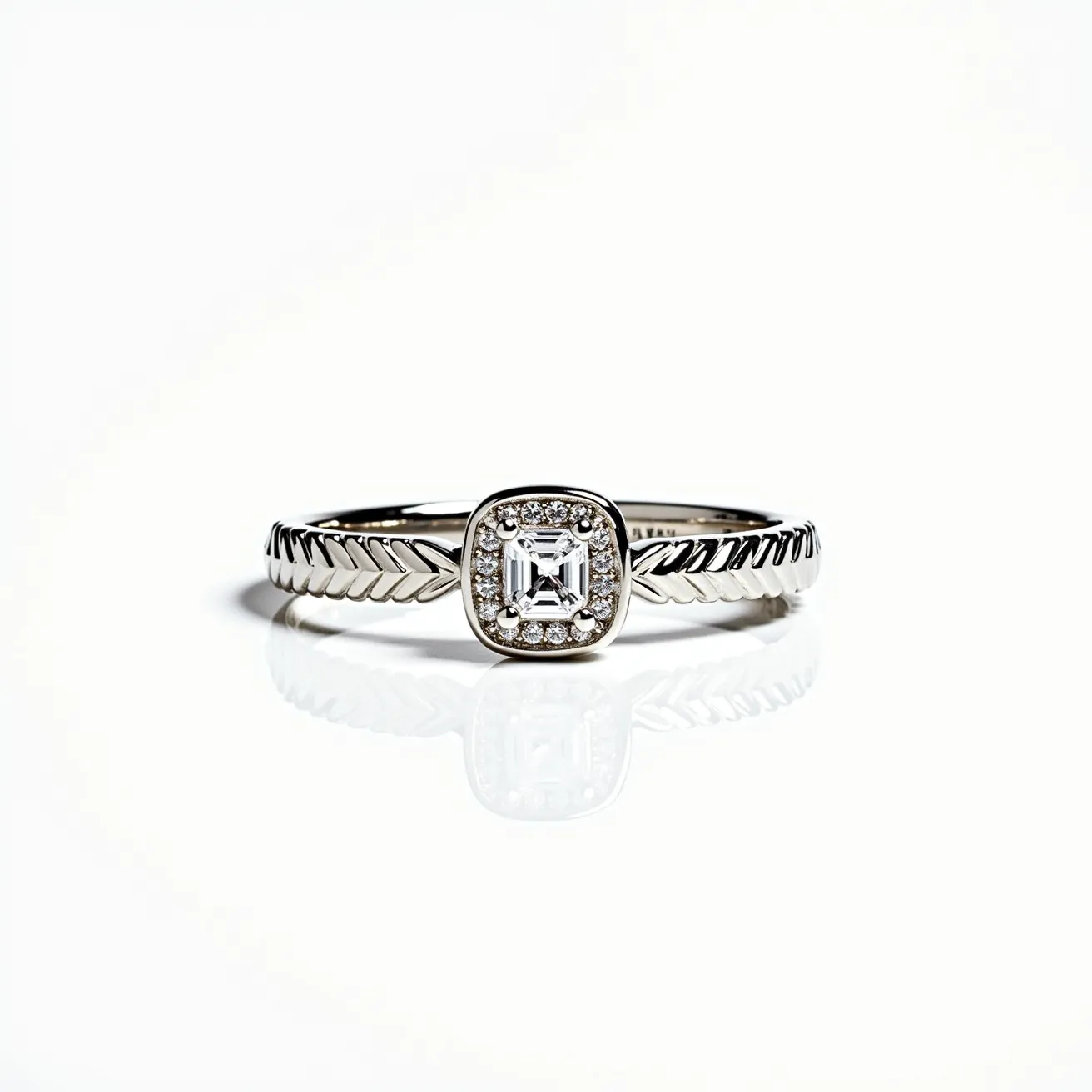 This wedding ring features a sleek band made of a lustrous metal, likely white gold or platinum, with a distinctive engraved pattern along the shank that resembles a braided or chevron design. At the center, there is a prominent square-cut diamond, possibly an Asscher cut, set in a bezel setting which is framed by a halo of smaller round diamonds that add to its brilliance. The overall design beautifully combines a modern aesthetic with a touch of vintage elegance.