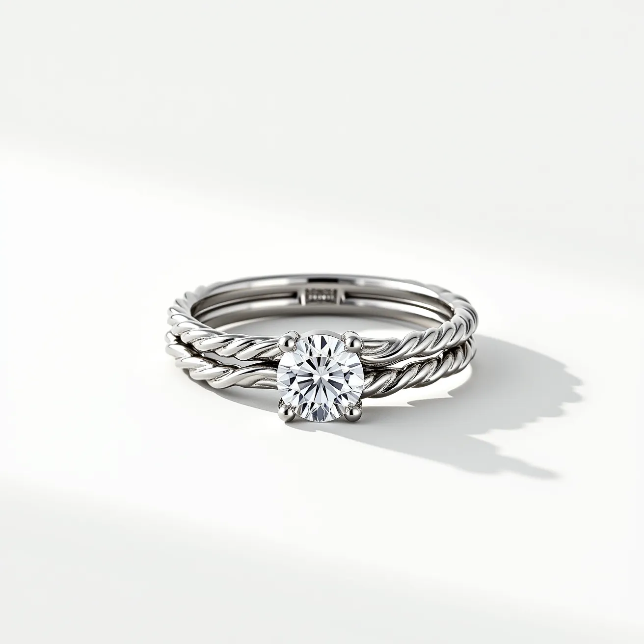 This wedding ring set features a beautifully crafted design with materials that appear to be silver or white gold. The set includes two rings, each with a twisted band design that adds a unique and elegant texture. The central ring showcases a round brilliant-cut diamond, securely held in place by a classic prong setting, which enhances the stone's brilliance and keeps it secure. The combination of the twisted bands and the solitaire diamond provides a timeless and sophisticated look perfect for a wedding or engagement set.