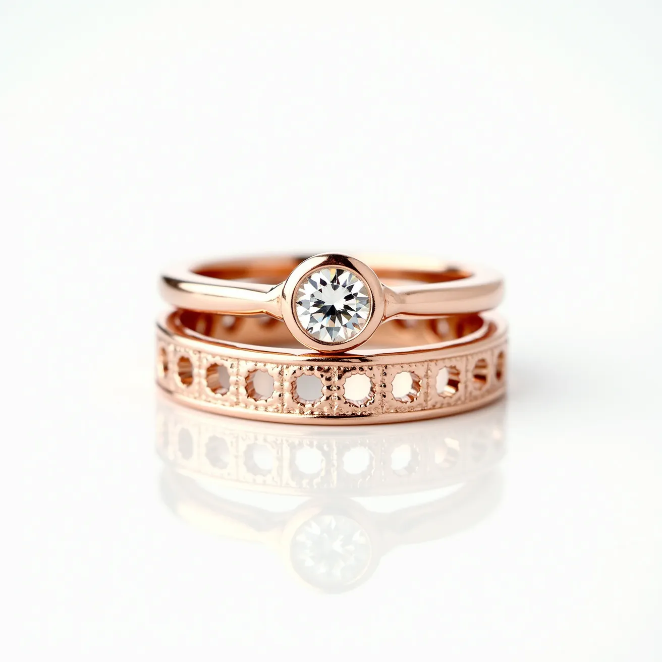 These wedding ring sets feature a striking blend of materials and design elements, showcasing rose gold bands that exude elegance and warmth. The first ring prominently displays a solitaire round-cut diamond secured in a bezel setting, offering a modern and sleek aesthetic. Complementing this, the second ring is crafted with intricate openwork detailing, presenting a delicate pattern of circular cutouts along its band. The craftsmanship and combination of materials in this set create a cohesive and stylish look, perfect for those who appreciate contemporary design with a touch of classic elegance.