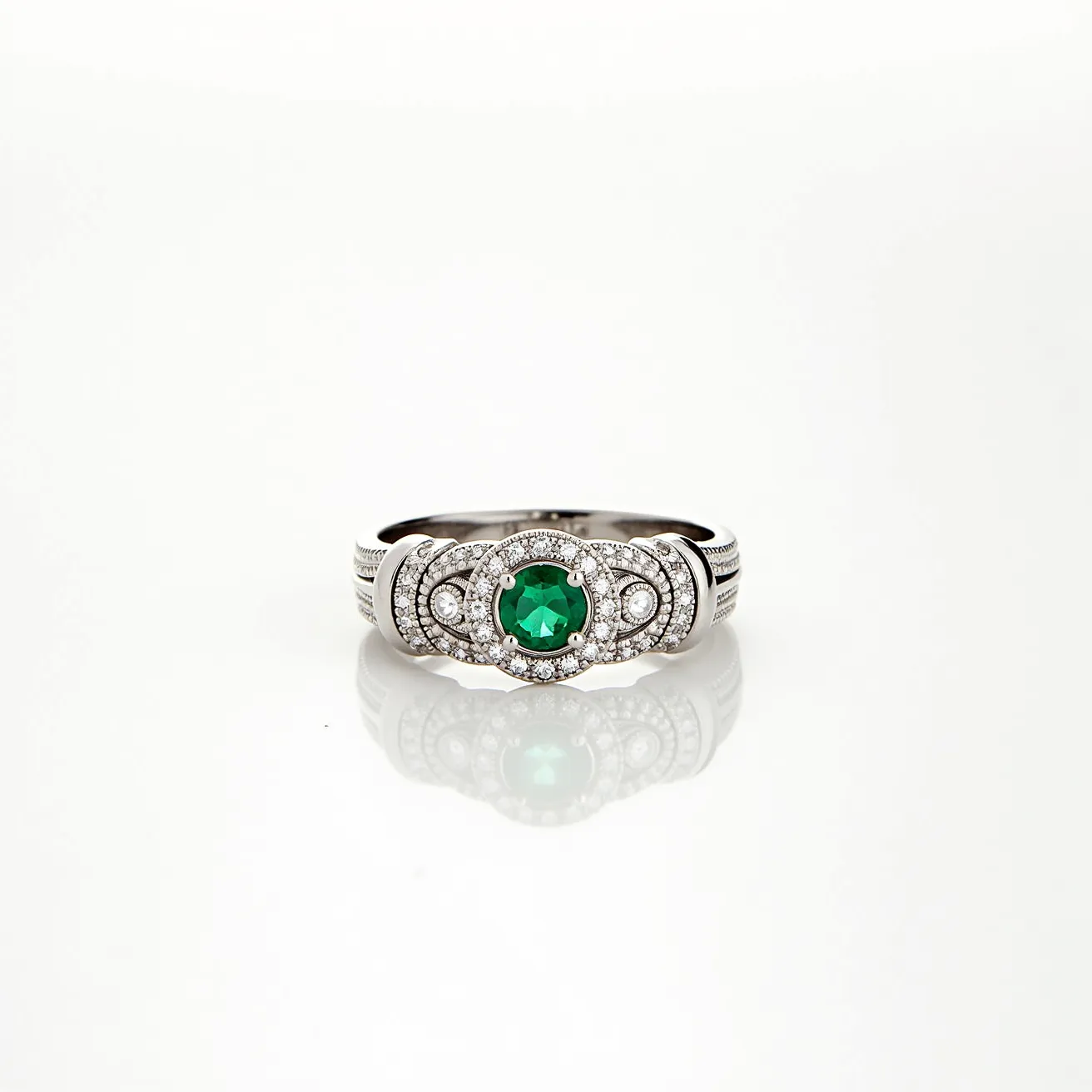 This western wedding ring features a prominent round-cut green gemstone at its center, likely an emerald, which is elegantly set in a secure prong setting. Surrounding the central stone is a halo of smaller round-cut white gemstones, possibly diamonds, enhancing the ring's brilliance and adding a touch of sophistication. The band itself appears to be crafted from a sleek metal, possibly white gold or platinum, and is adorned with intricate detailing along its surface, contributing to the ring’s overall ornate design. The combination of the central green gem, sparkling halo, and the refined band design gives this wedding ring a classic and luxurious appeal.