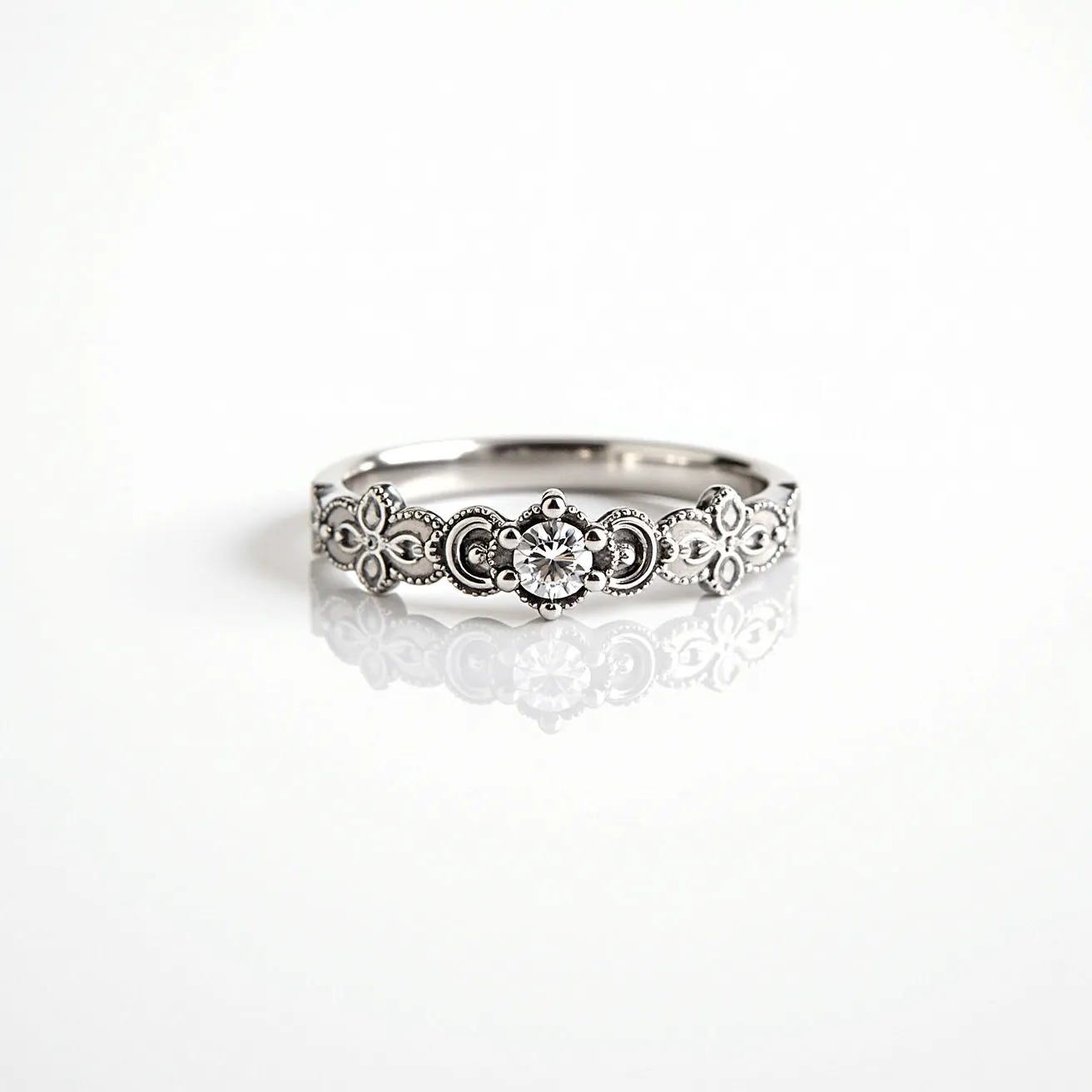 This western wedding ring features a band made of a polished, likely silver or white gold material, showcasing intricate floral and circular designs that are meticulously carved along its surface. At the center, a round-cut diamond is securely set within a floral pattern, acting as the focal point of the ring's ornate design. The stone is held in place by prongs that seamlessly blend into the artistic detailing of the band. Flanking the central stone, the band continues with smaller, complementary motifs, contributing to an overall vintage and elegant aesthetic. The design does not include a clasp, as it is a traditional band meant to slide onto the finger.

