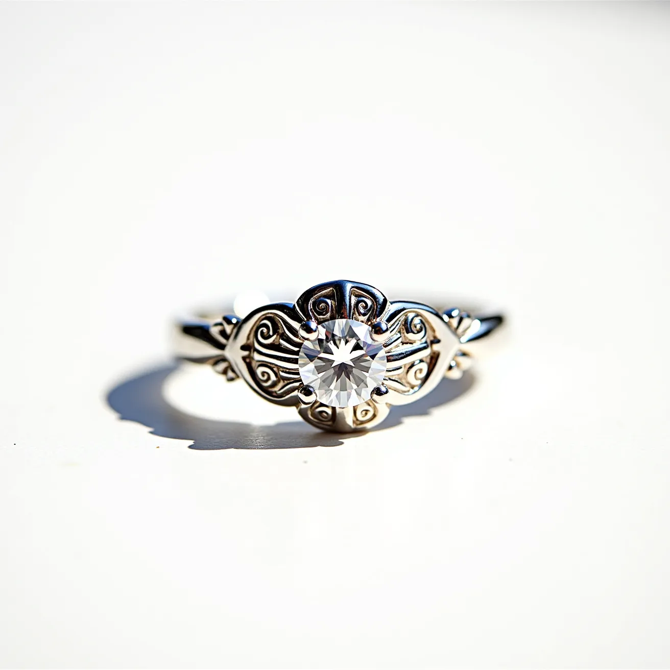 This western wedding ring features an ornate silver band adorned with intricate scrollwork detailing, reflecting a blend of tradition and elegance. At its center, a round, brilliant-cut gem, likely a diamond, is securely held in place by a four-prong setting, which allows maximum light to pass through and enhance the stone’s sparkle. The ring’s design is sophisticated, with the silver providing a brilliant contrast to the clarity of the gem, creating a stunning visual effect. The craftsmanship suggests a piece meant to capture both romance and refined style, integral to its symbolic significance.