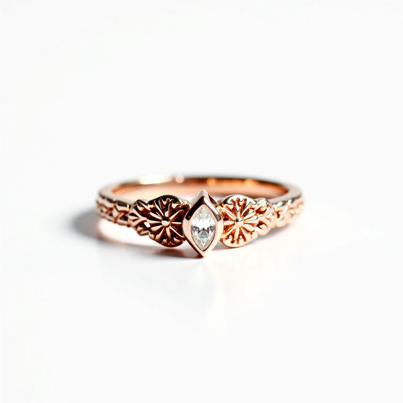 This western wedding ring is crafted from a warm rose gold material, exhibiting intricate floral filigree detailing along its band. It features a prominent marquise-cut gemstone at its center, securely set in a bezel setting which accentuates its elegant shape. The combination of the ornate design and the central gemstone creates a harmonious and romantic aesthetic typical of western wedding rings.