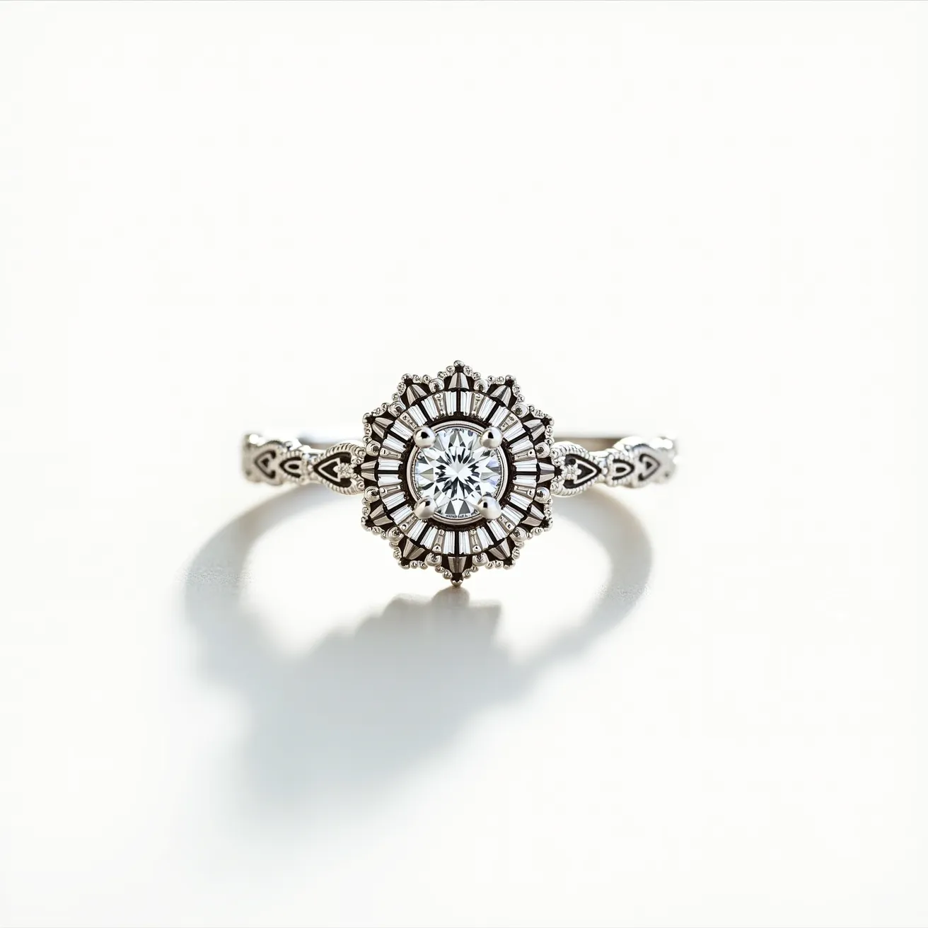 This white gold ring features an intricate design with a central round-cut diamond that serves as the focal point. Surrounding the central stone is a detailed halo of baguette-cut diamonds arranged in a sunburst pattern, enhancing its brilliance and adding a vintage-inspired flair. The band itself is adorned with ornate patterns, including tiny heart-shaped motifs, contributing to its elegant and distinctive look. The stones are set securely, complementing the ring's elaborate yet cohesive design.